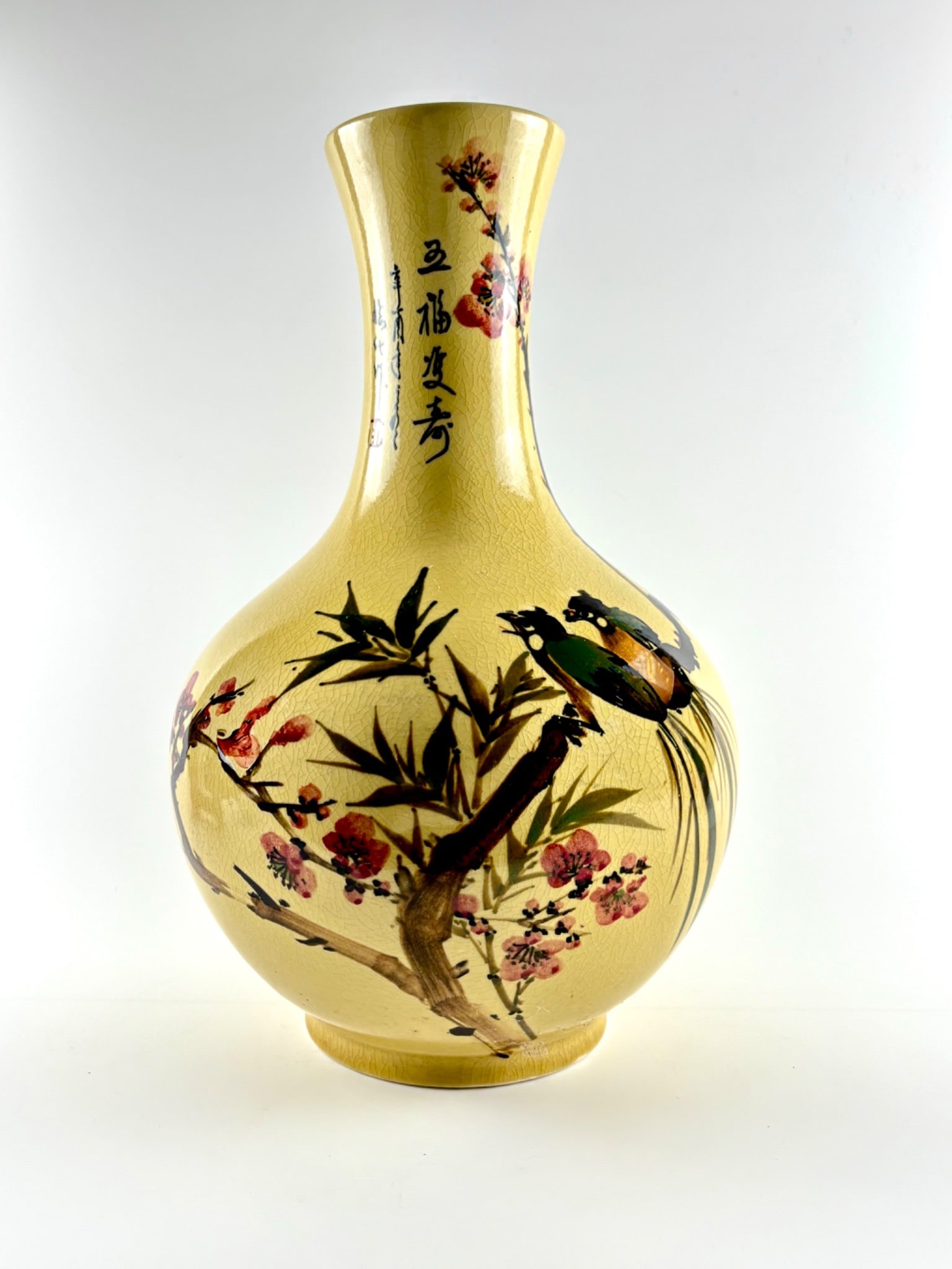 Mid-Century Qing Dynasty Revival Export Vase: Qing Dynasty revival export vase featuring a pale yellow crackle glaze. The bulbous body and elongated neck are decorated with hand painted motifs, including birds perched on a flowering branch, bambo