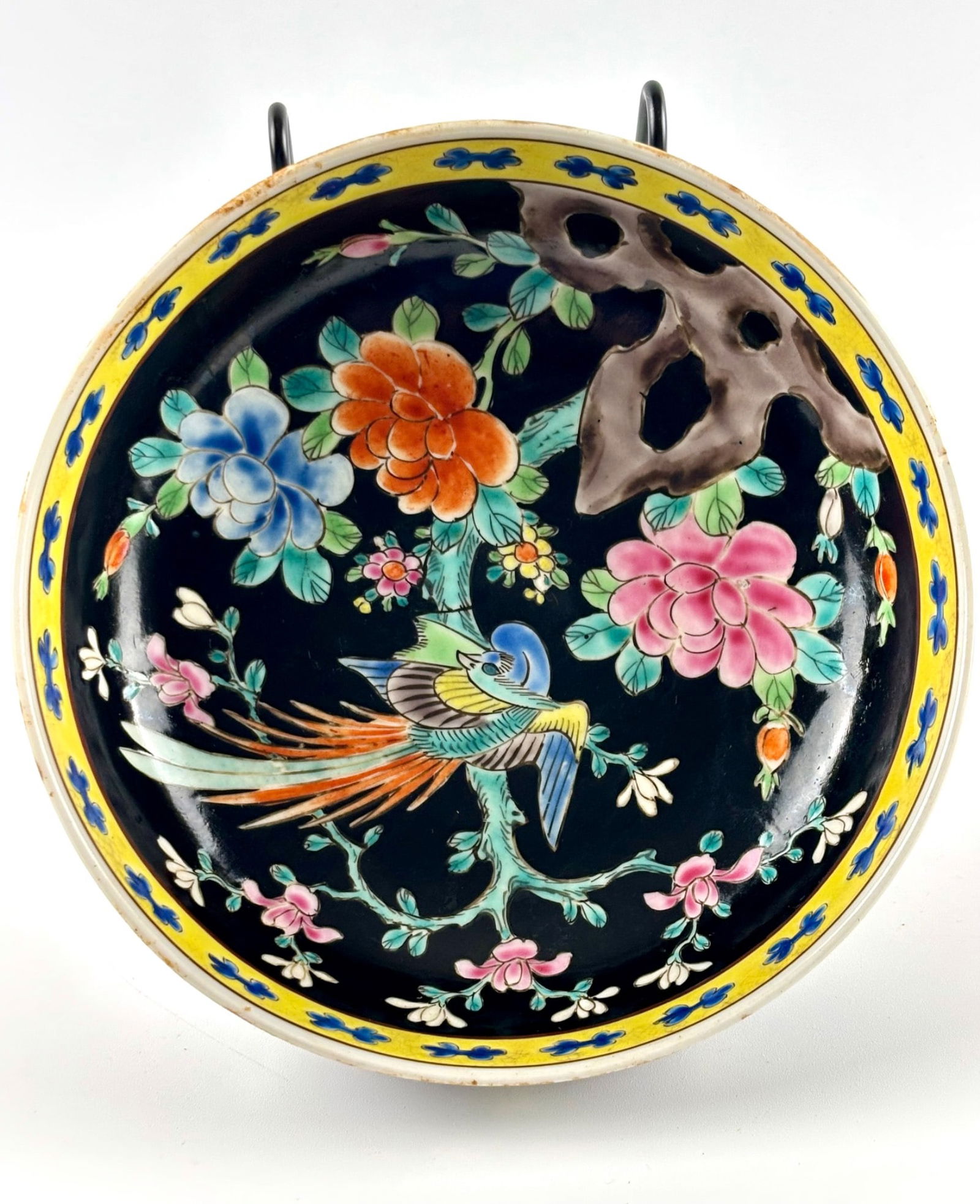 Nippon Marked Porcelain Bowl with Colorful Floral and Bird Motif: Porcelain bowl featuring a black-glazed interior adorned with hand-painted floral designs, a vibrant bird motif, and a yellow decorative border. The exterior is decorated with floral and branch motifs