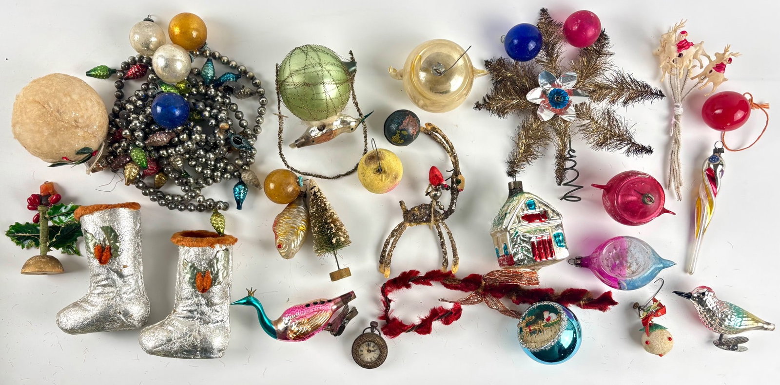 Vintage Christmas Ornaments: Vintage Christmas ornaments in various materials and forms. Includes hand blown glass ornaments with foil and glitter decorations, silver tone bead garland with fruit motifs, foil wrapped boot ornamen
