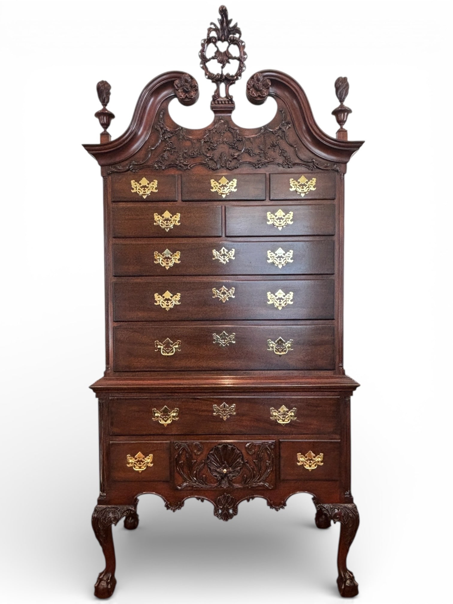 Kindel Philadelphia Mahongany Highboy: Kindel highboy in Philadelphia Chippendale style, crafted from rich mahogany. Features an ornate broken arch pediment with hand carved floral and foliate details, central pierced finial, and flanking