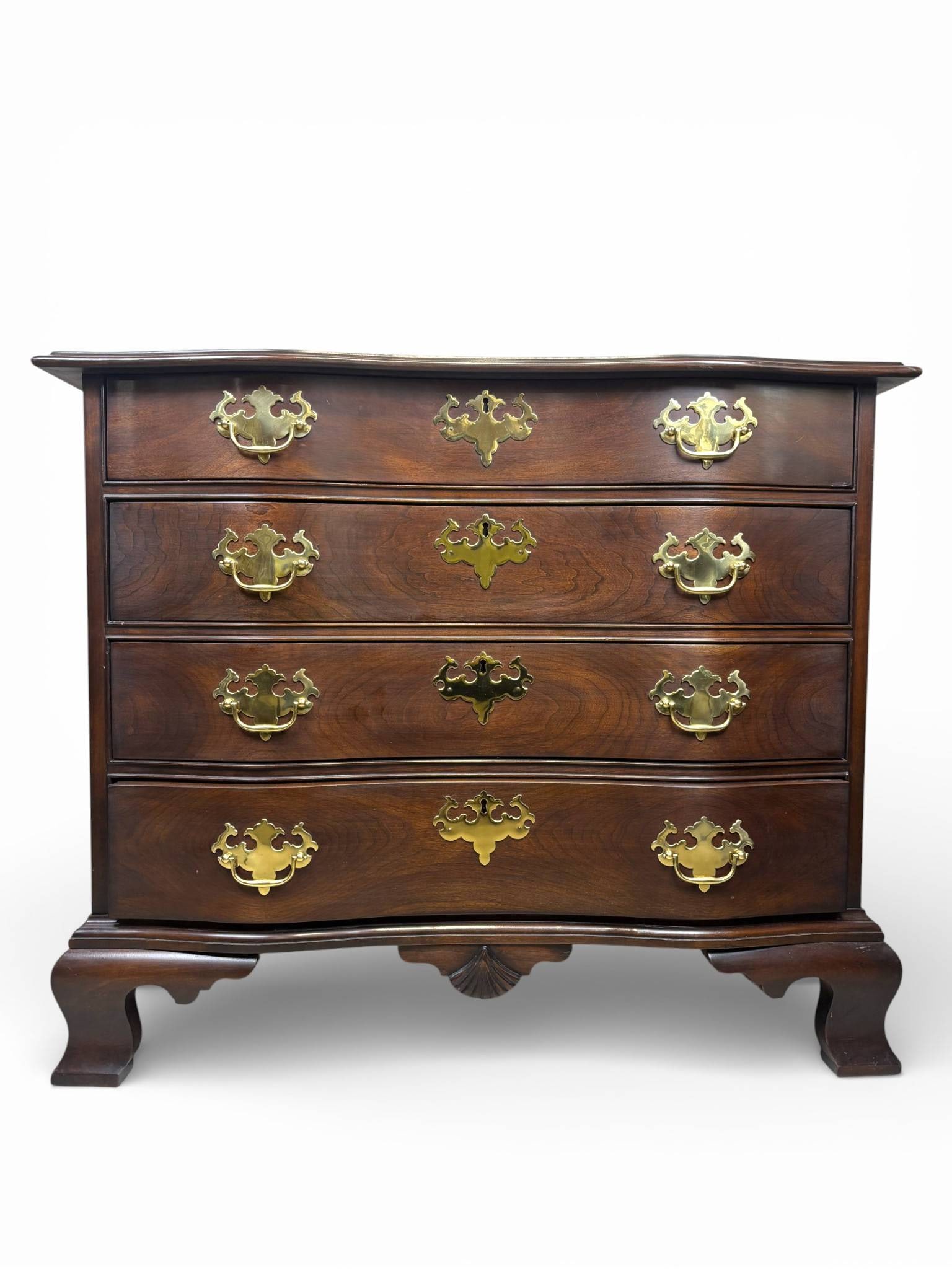Statton Furniture Serpentine Chest of Drawers with Brass Bail Pulls: Statton Furniture Colonial Revival style serpentine chest of drawers crafted in richly finished hardwood, dating to the late 20th century. Features a four drawer configuration with brass Chippendale