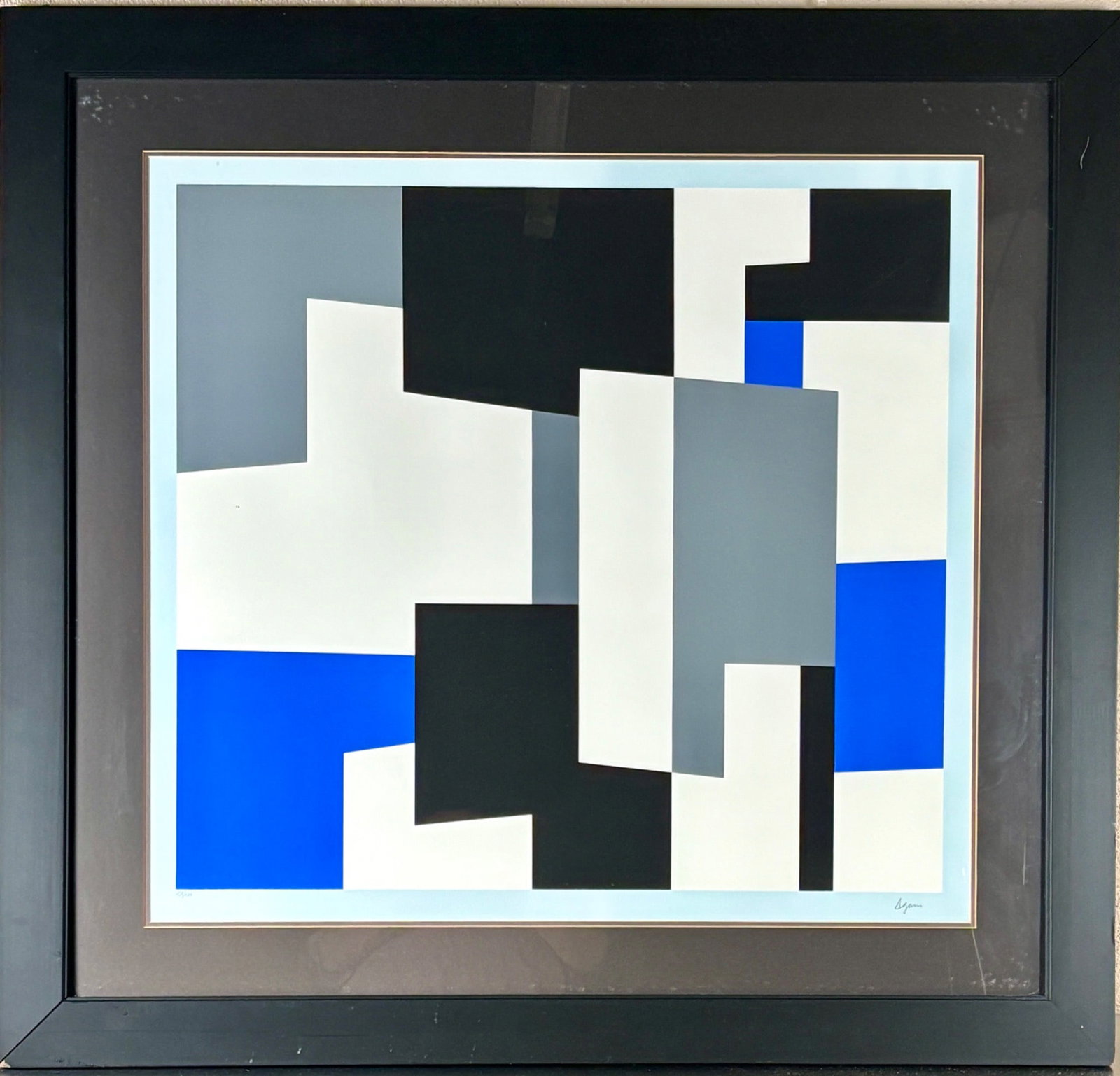 Signed Agam Limited Edition Serigraph: Signed limited edition serigraph by Agam, numbered 139 of 144 and featuring an abstract geometric composition in black, white, gray, and blue. Professionally framed under glass in a black wood frame w