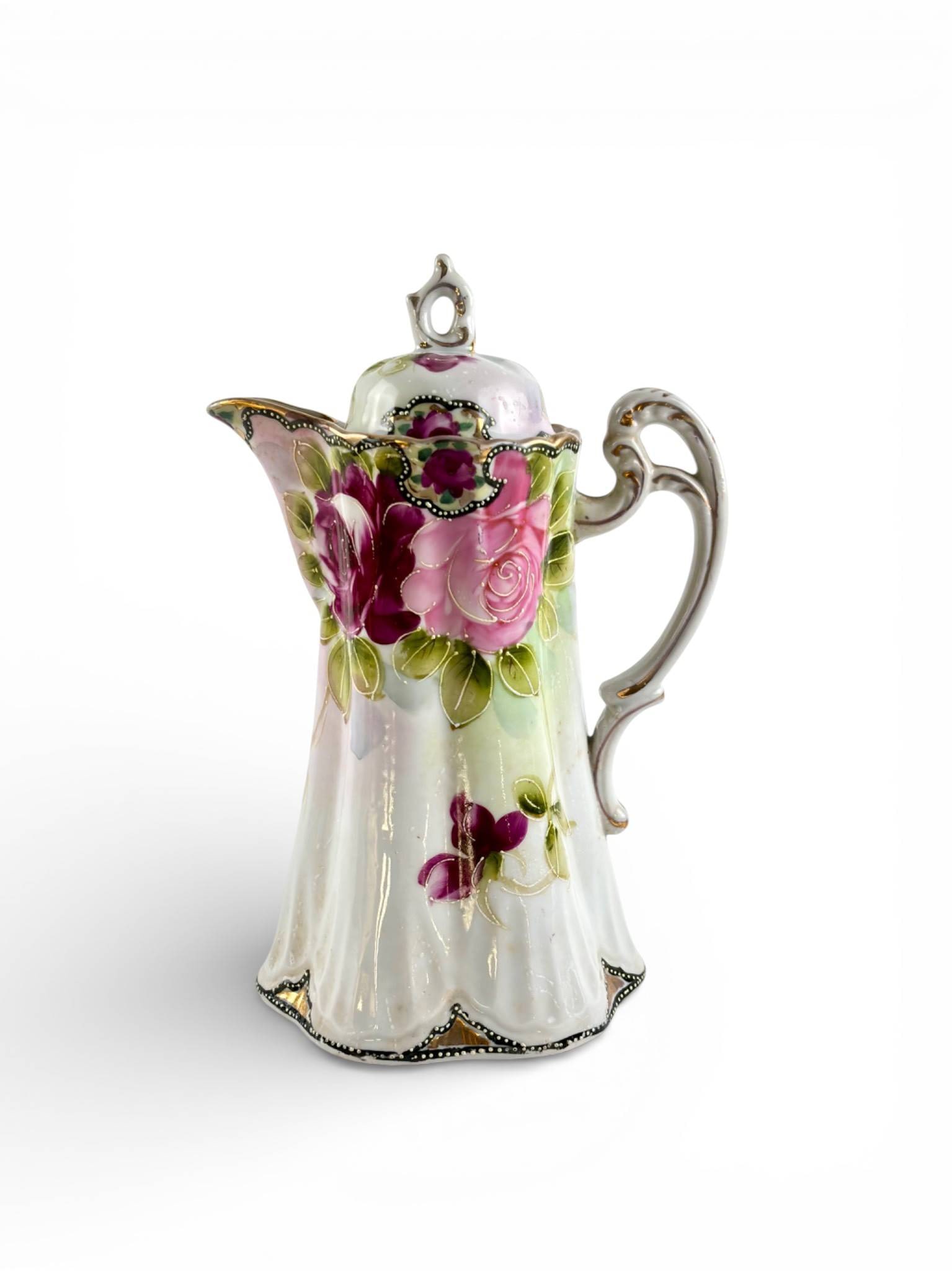 Hand-Painted Nippon Porcelain Chocolate Pot with Floral Design: Hand painted Nippon porcelain chocolate pot with an ornate floral design featuring pink roses, green leaves, and gold trim accents. Includes a matching lid with a looped finial. The base is marked
