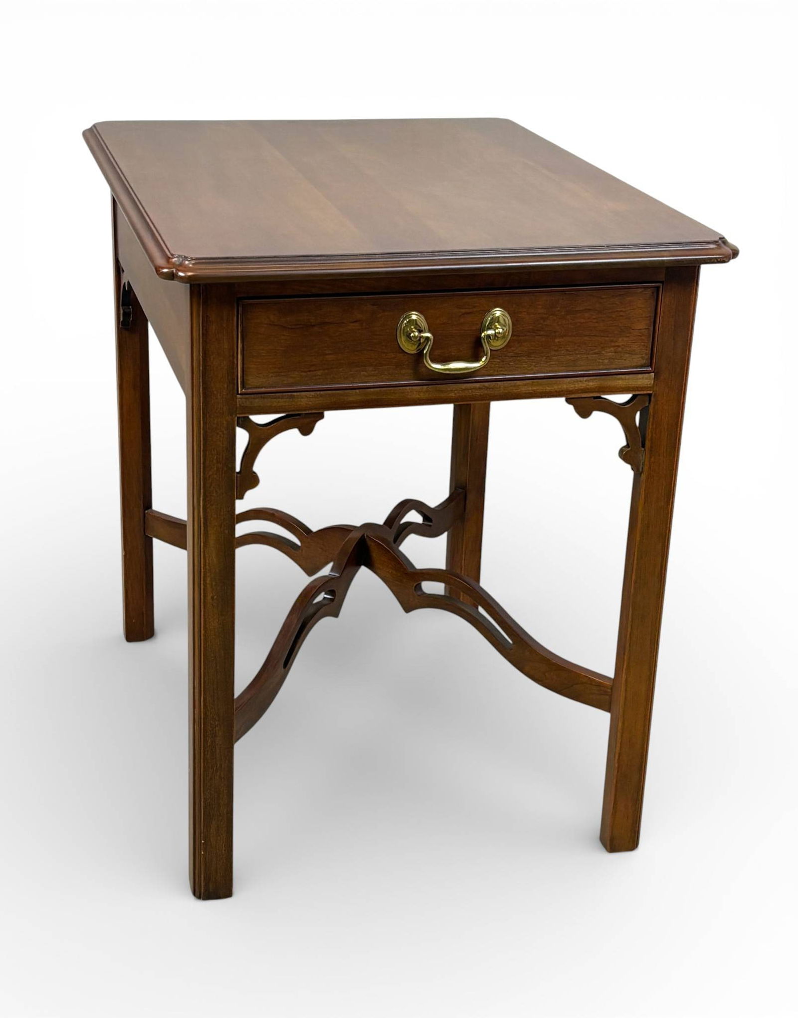 Statton Cherry Wood Side Table with Single Drawer: Statton cherry wood side table featuring a single dovetail constructed drawer with brass pull hardware. The table showcases a decorative stretcher with curved accents and detailed aprons. The