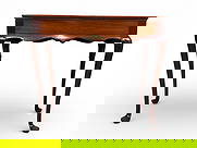 Mahogany Side Table with Cabriole Legs and Extending Side Panels: Mahogany side table featuring a rectangular top with a raised lip and beveled corners. The table includes cabriole legs terminating in pad feet, a central drawer with brass knob, and two extending