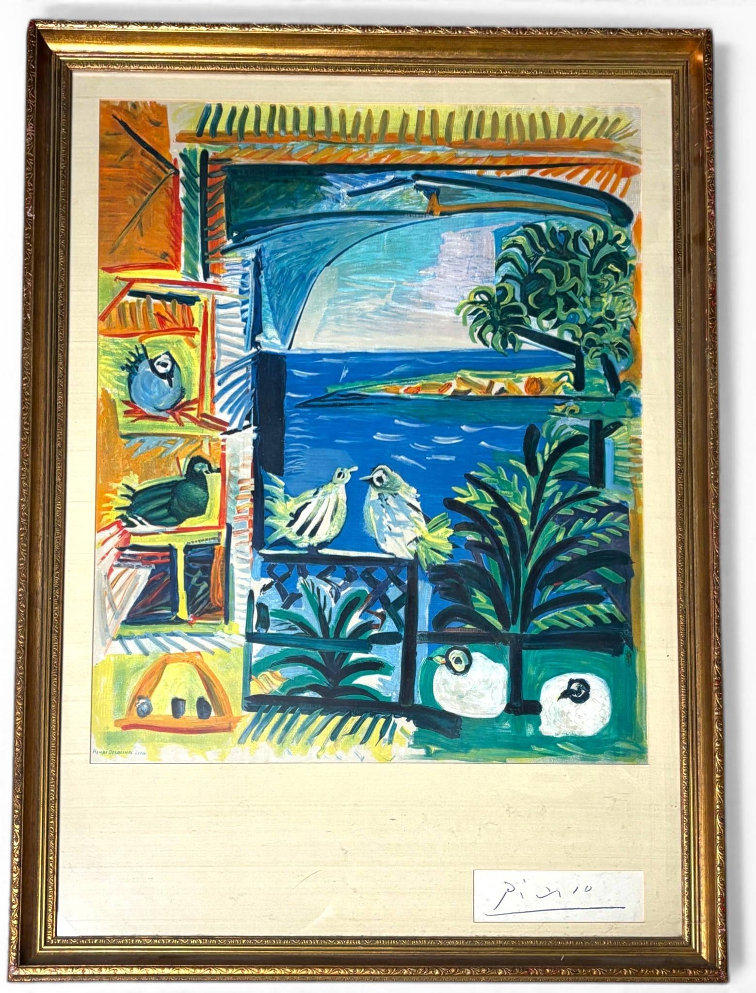 Pablo Picasso Cote D Azur Lithograph in Colors Henri Deschamps: Lithograph in colors after Pablo Picasso titled Cote D Azur, printed by Henri Deschamps. Features vivid depictions of birds, foliage, and a coastal landscape. Mounted within a gold-tone frame. Comes w