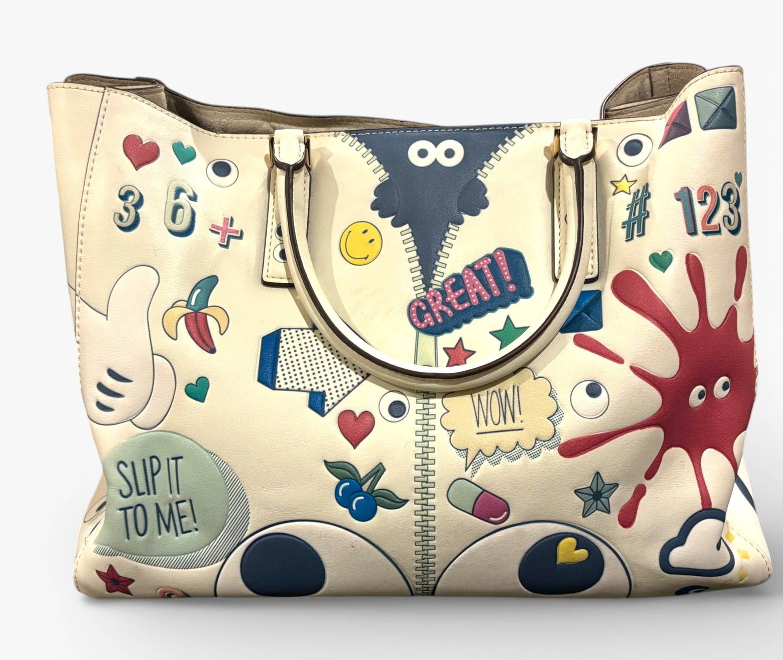 Anya Hindmarch Bathurst Small Satchel: An Anya Hindmarch Bathurst Small Satchel crafted in Italy, featuring light grey Capra leather with a vibrant all over Wink Stickers print. Accented with metallic Capra leather trim and dual carry hand