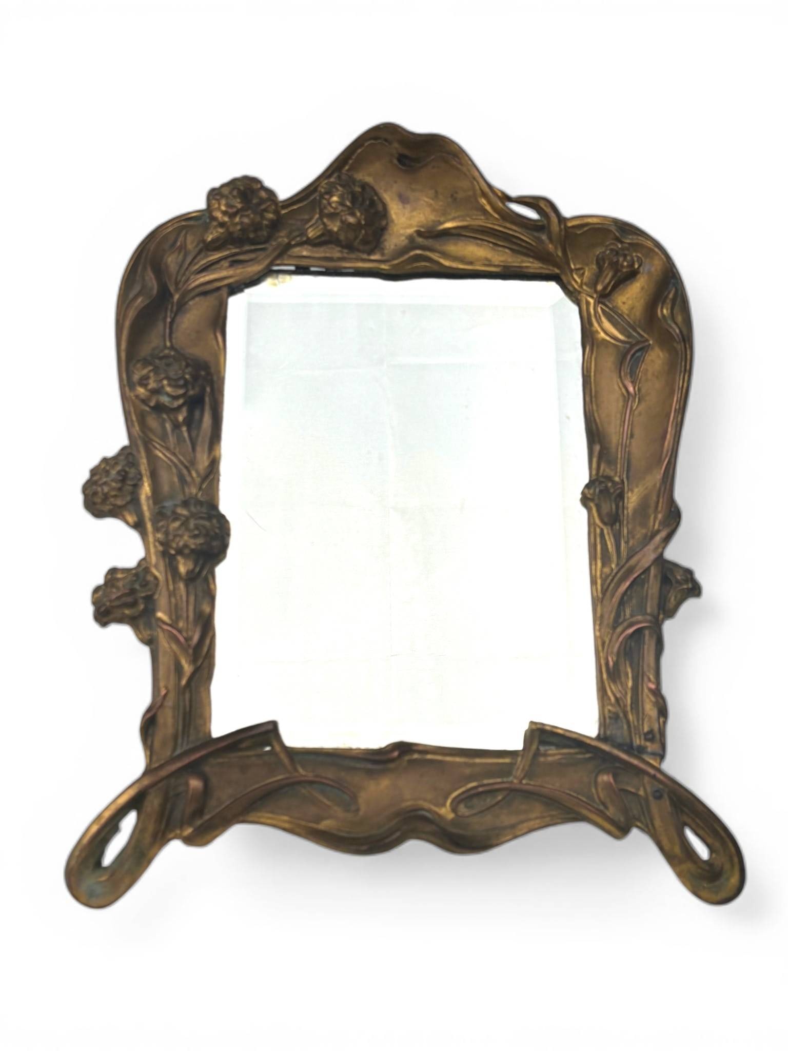 Antique Art Nouveau Tabletop Mirror with Floral Brass Frame: Antique Art Nouveau tabletop mirror featuring a brass frame adorned with floral motifs and curvilinear details characteristic of the Art Nouveau style. The mirror pane is slightly cloudy, indicative