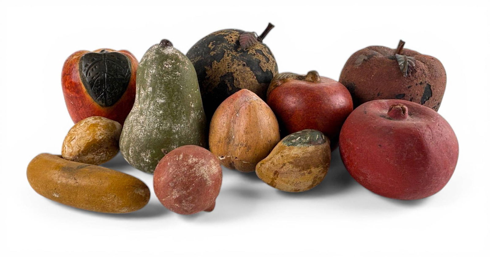 Handcrafted Painted and Carved Wooden and Ceramic Fruits: Handcrafted decorative fruits made from painted and carved wood. Includes pieces resembling apples, pears, lemons, and other fruits with varying textures, colors, and patinas. Some items show wear