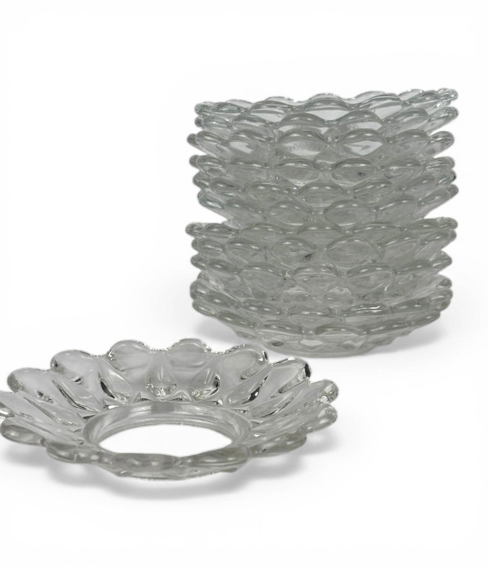 Baccarat Crystal Bobeches with Scalloped Edges: Baccarat crystal bobeches designed with scalloped edges and a clear, faceted surface that reflects light beautifully. Each piece features an open center for fitting around candleholders. The set demon