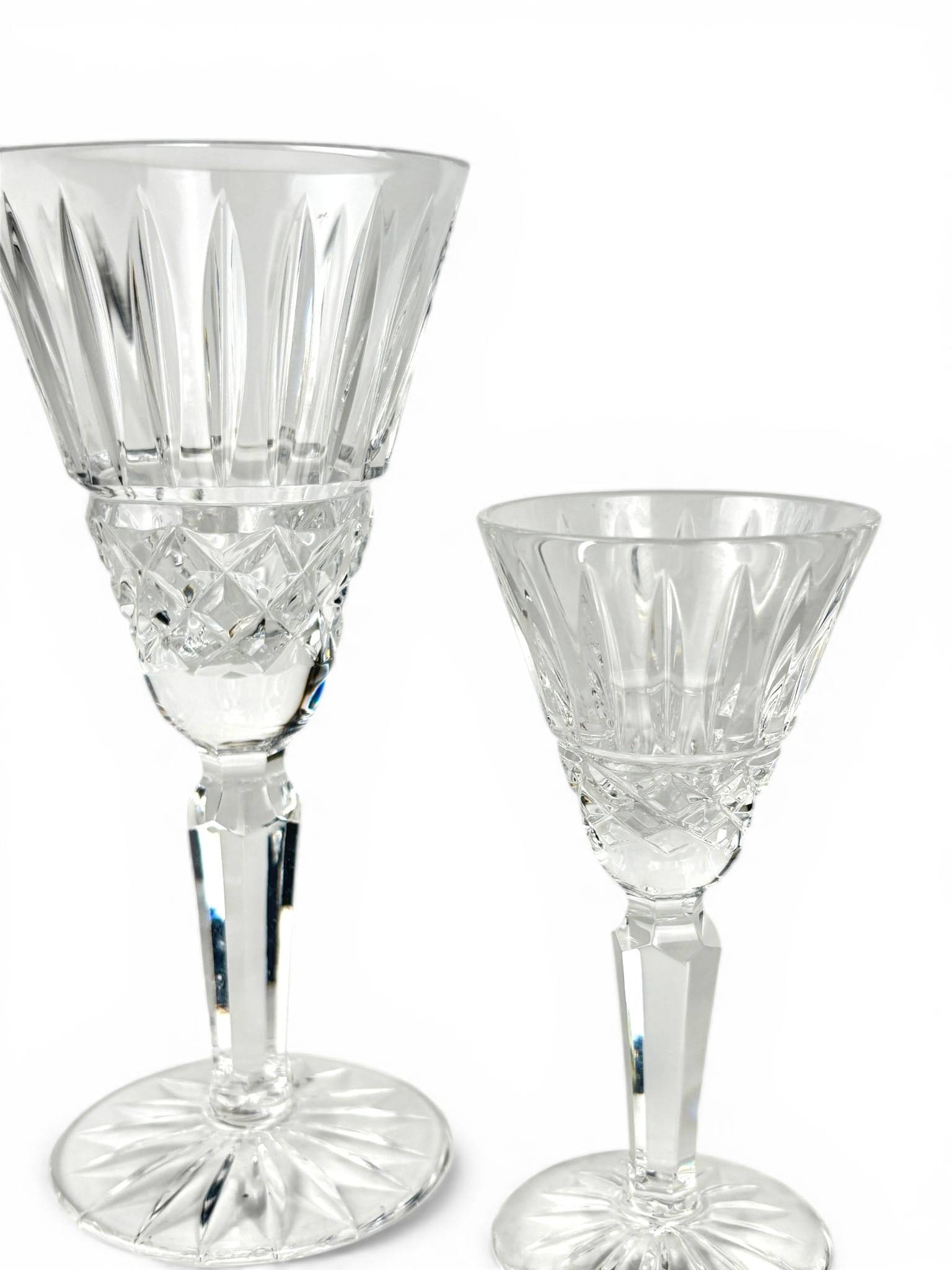 Waterford Maeve Cut Crystal Wine Glasses: Cut crystal wine glasses from Waterford in the Maeve pattern. Features vertical and cross-cut details on the bowl and a fluted stem with a starburst-cut base. Each glass displays the fine