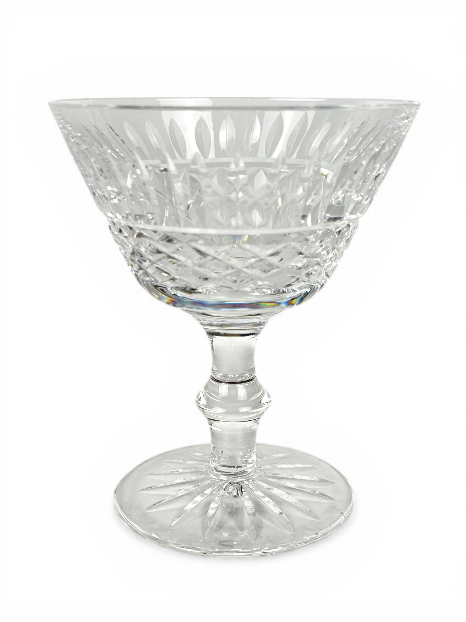Eight Waterford Tramore Crystal Sherbet Glasses: Eight Waterford crystal sherbet glasses in the Tramore pattern. Featuring a traditional cut glass design with diamond and vertical cuts, each piece displays masterful craftsmanship. The stems are