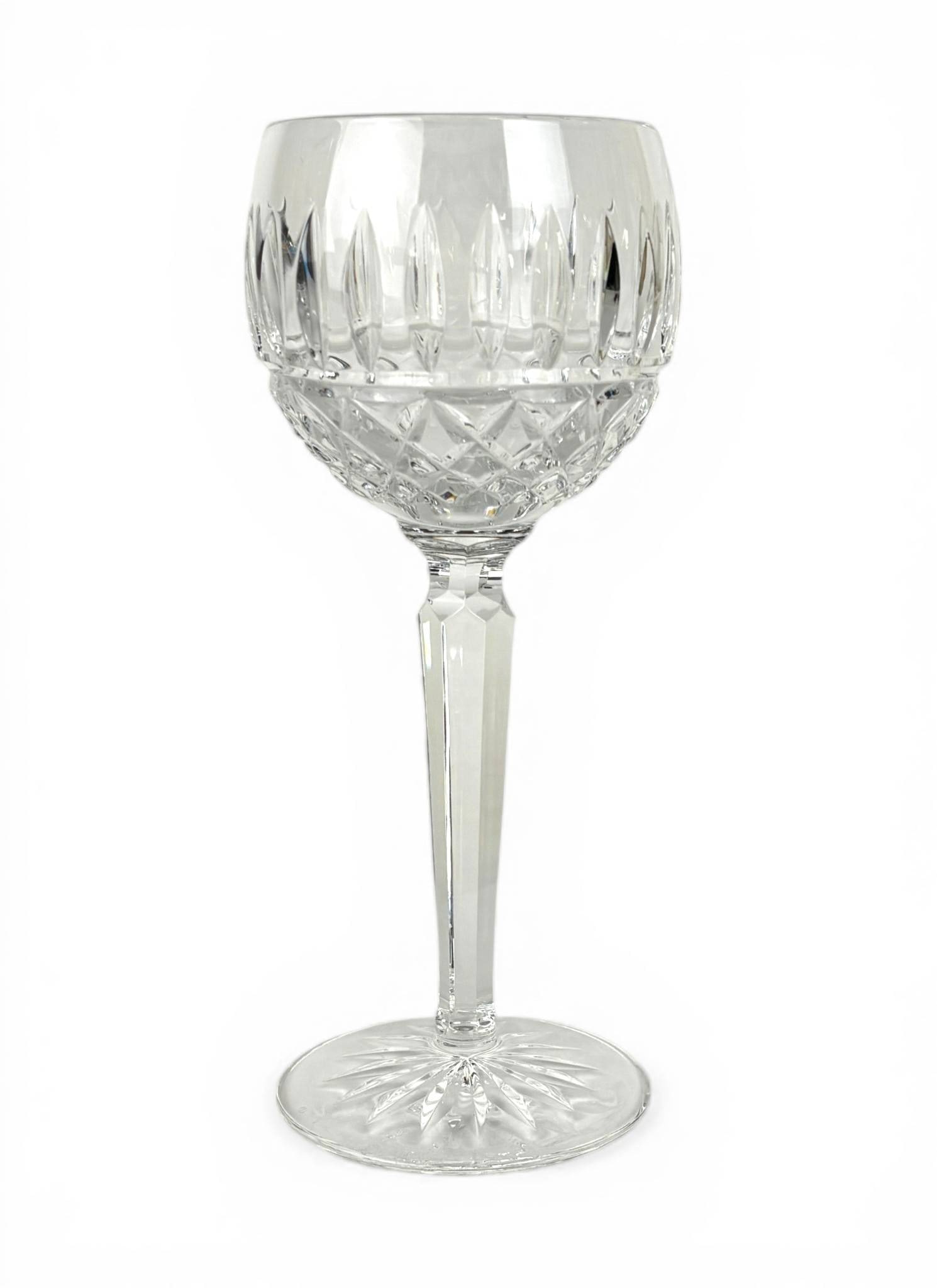 9 Waterford Maeve Pattern Crystal Wine Hocks: 9 Waterford crystal wine hocks in the Maeve pattern, featuring a cut glass design with vertical cuts and crosshatch details. One glass has a visible chip on the rim as shown in the images. Overall