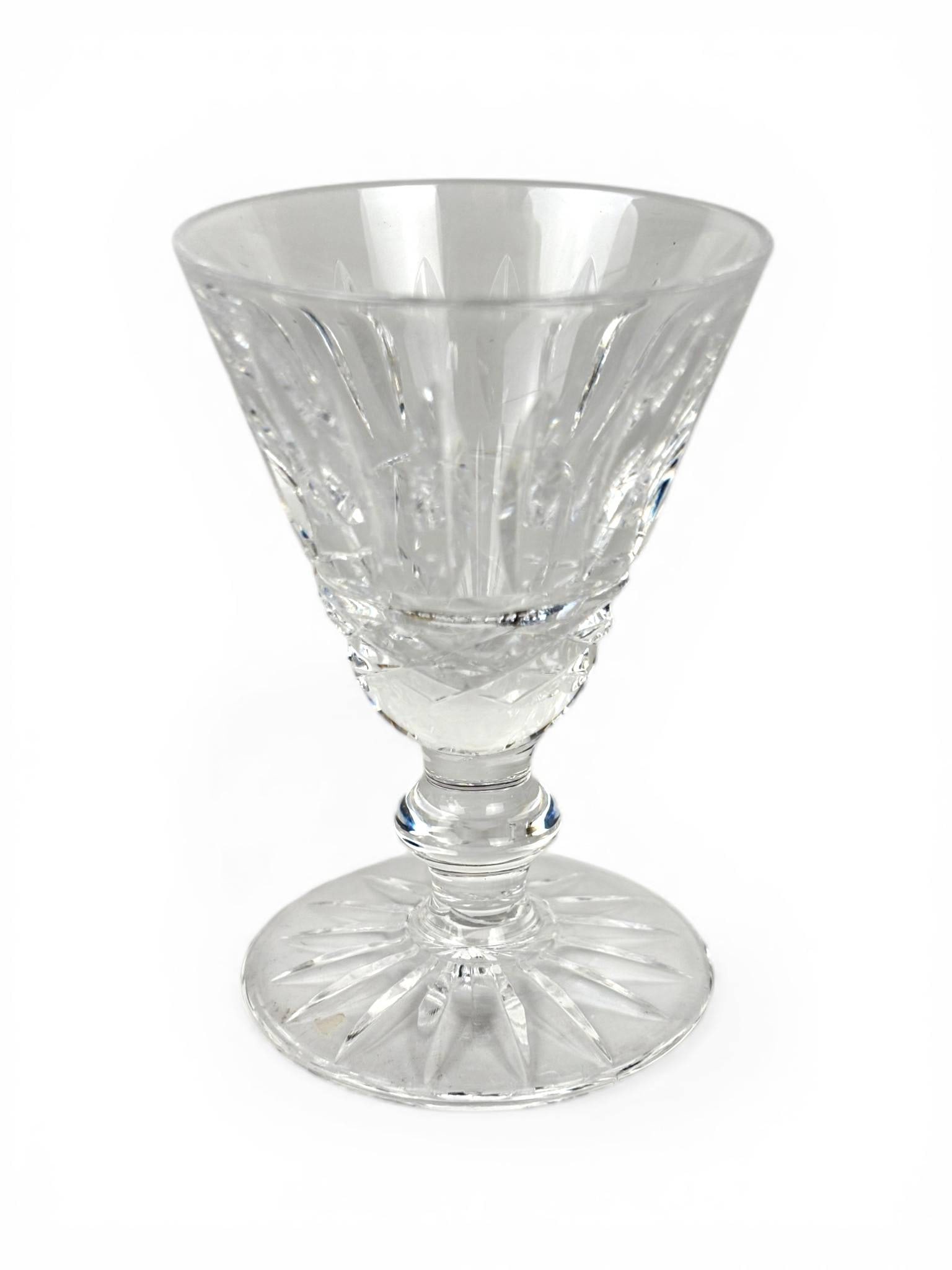Eight Waterford Maeve Crystal Cordials: Eight Waterford Maeve pattern crystal cordials, featuring faceted bowls with vertical cuts and starburst designs on the foot. Each measures approximately [dimensions not provided]. The cordials are