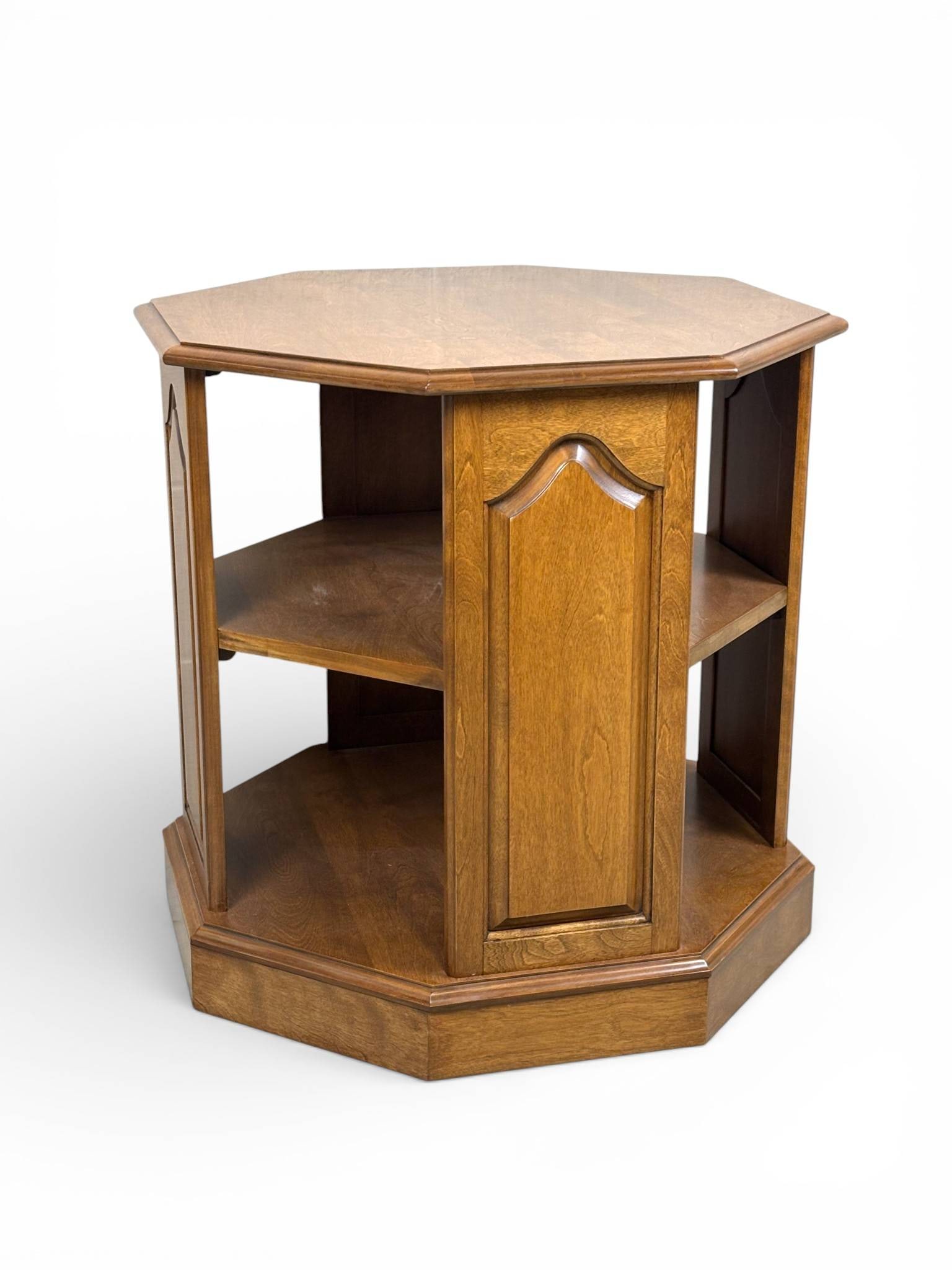 Ethan Allen Georgian Court Cherry Octagonal Accent Table: Ethan Allen Georgian Court series octagonal accent table crafted from solid cherry wood. Features a tiered design with two open shelves and decorative arched paneling on each side. The table stands