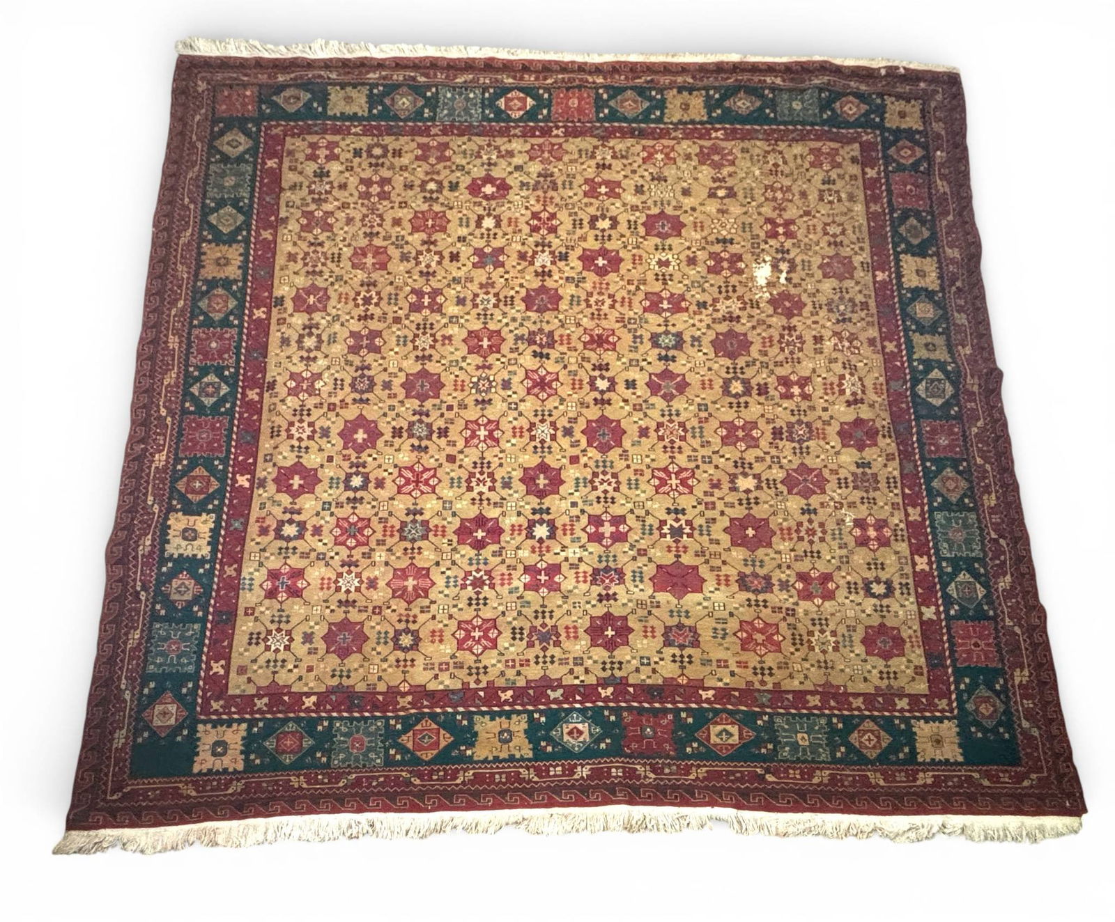 Iranian Handwoven Rug with Geometric and Floral Patterns circa 1950: Handwoven wool rug from Iran, dated to 1950. Features intricate geometric and floral motifs in red, beige, teal, and blue hues. The central field displays repeating star patterns enclosed by multiple