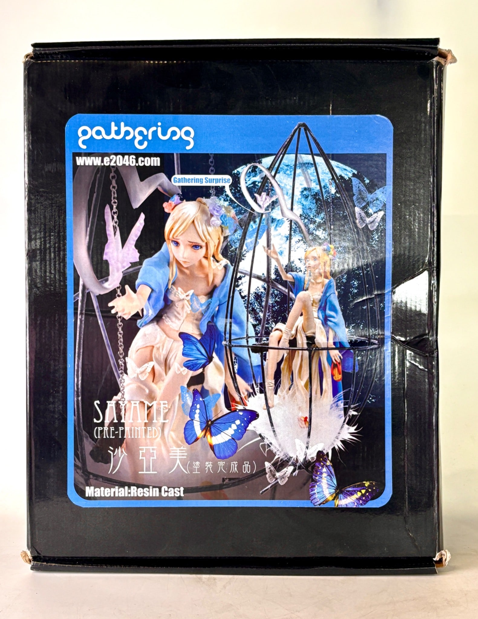 Gathering E2046 SAYAME Resin Figurine in Box: Gathering E2046 Sayame resin figurine, pre painted model. Depicts a detailed female character adorned with a blue cloak, butterflies, and seated within a metal cage like structure. Comes in the origin