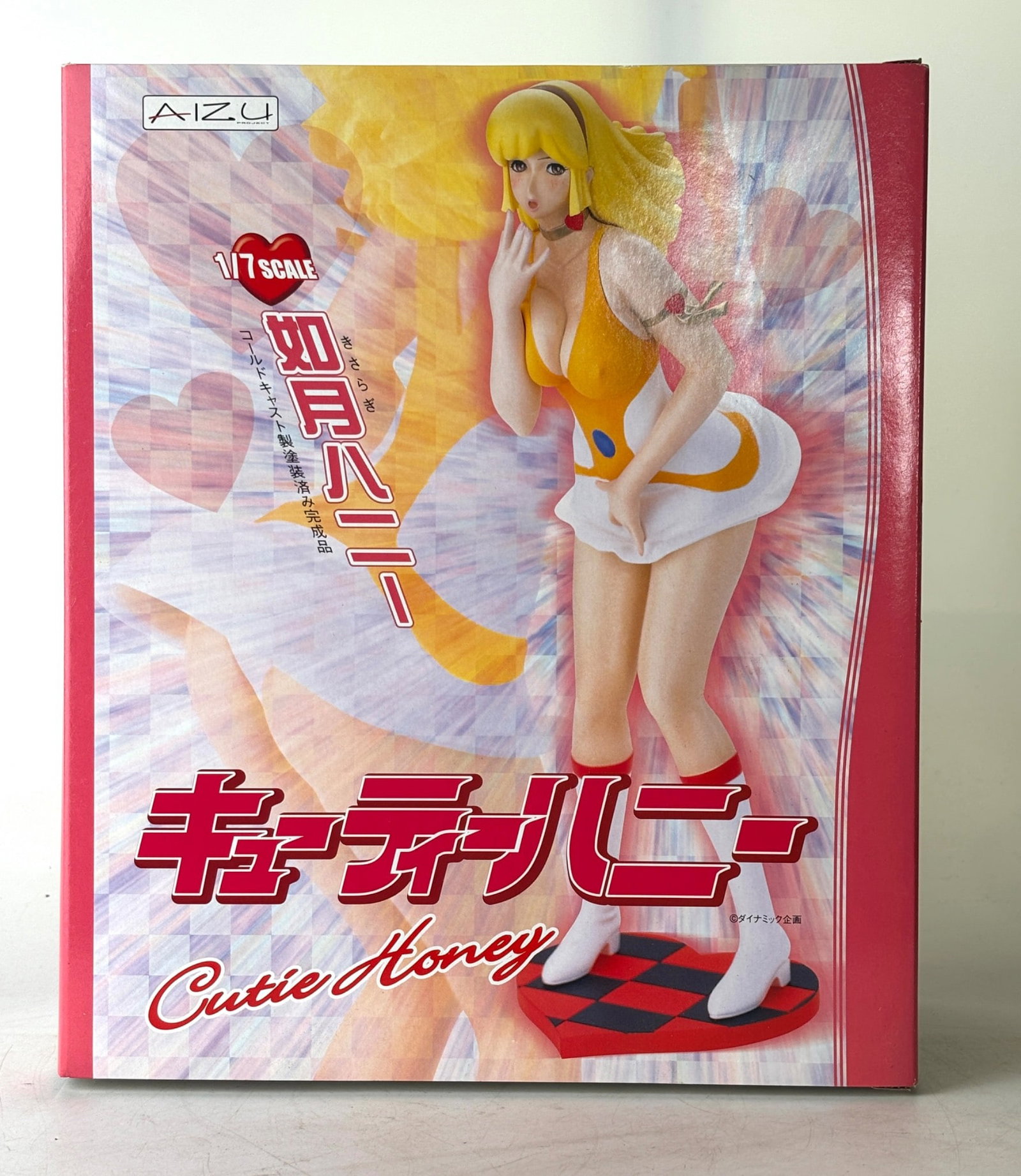 1/7 Scale Cutie Honey Resin Figure by Aizu Project: A 1/7 scale resin figure of Cutie Honey by Aizu Project, featuring vibrant coloration and a dynamic pose. The packaging displays images of the figure from various angles, along with production details