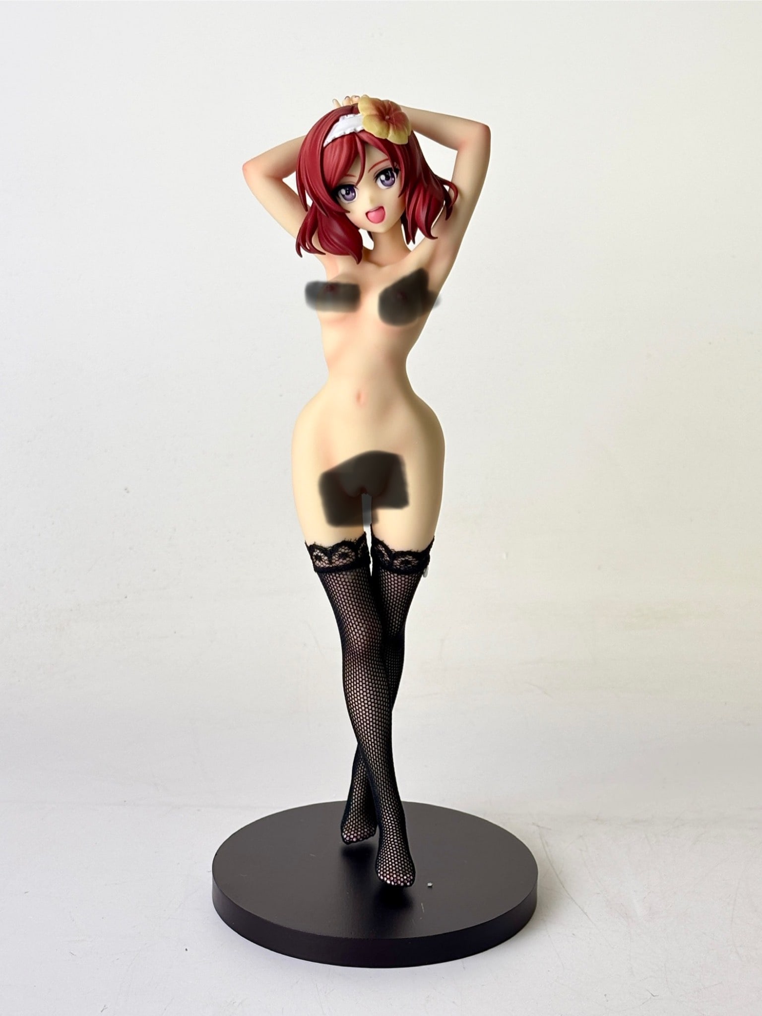 Banpresto Love Live Maki Nishikino PVC Figure: Banpresto PVC figure depicting Maki Nishikino from “Love Live.” The figure presents detailed craftsmanship, including textured stockings, a floral hair accessory, and vibrant color application