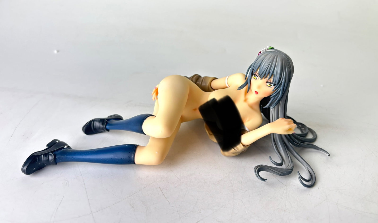 Sky Tube X-Eros Cover Girl Anime Figure: PVC collectible figure featuring a reclining anime character as illustrated by Aruchu Kizuki for Sky Tube X-Eros. Features detailed sculpting, gray hair, floral hair accessory, and a pose emphasizing 