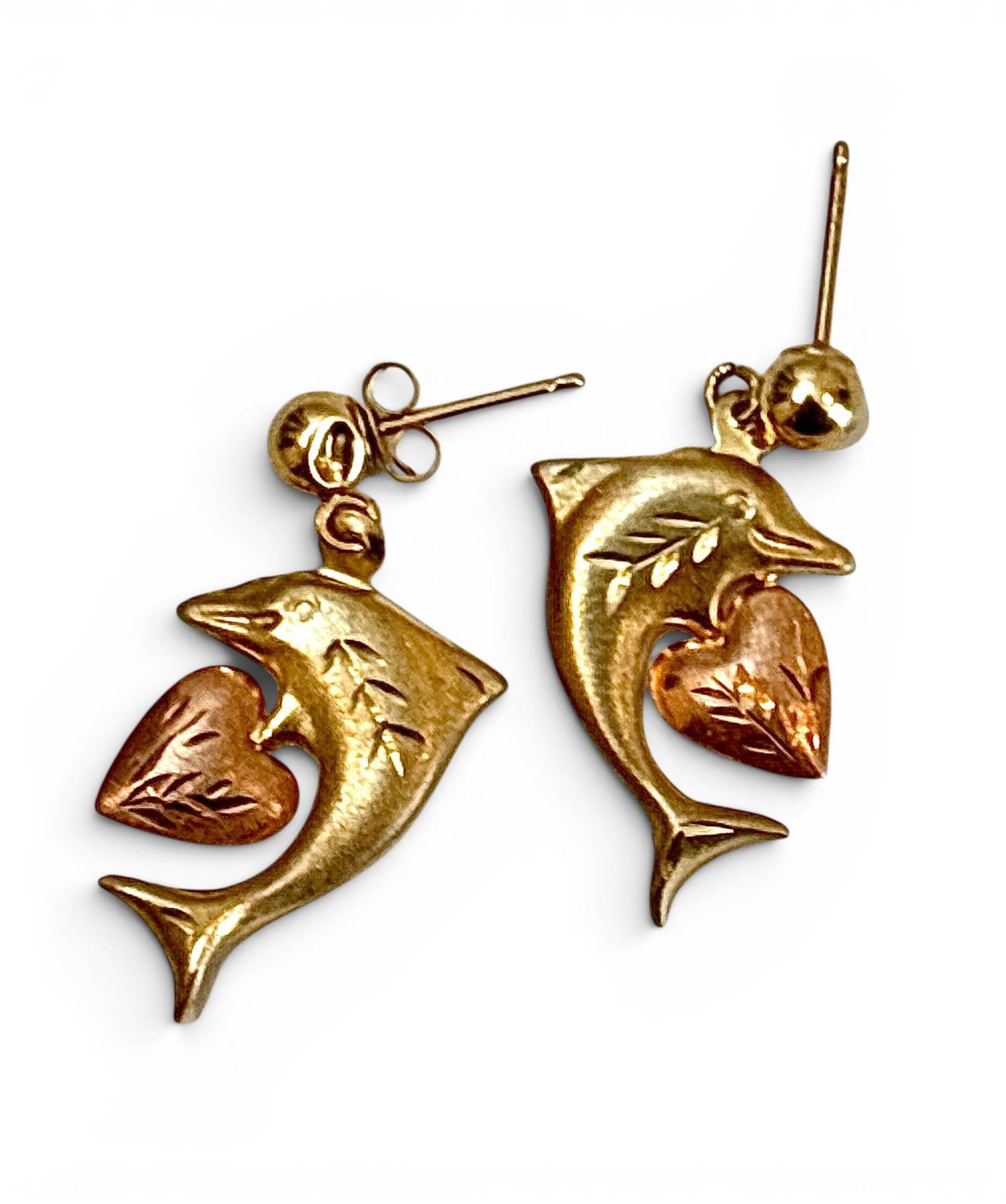 14K Gold Dolphin Earrings with Rose Gold Heats: 14K yellow gold earrings featuring dolphin motifs with rose gold heart accents. Detailed engraving on the dolphins and hearts adds texture to the design. Includes ball stud posts with butterfly backin