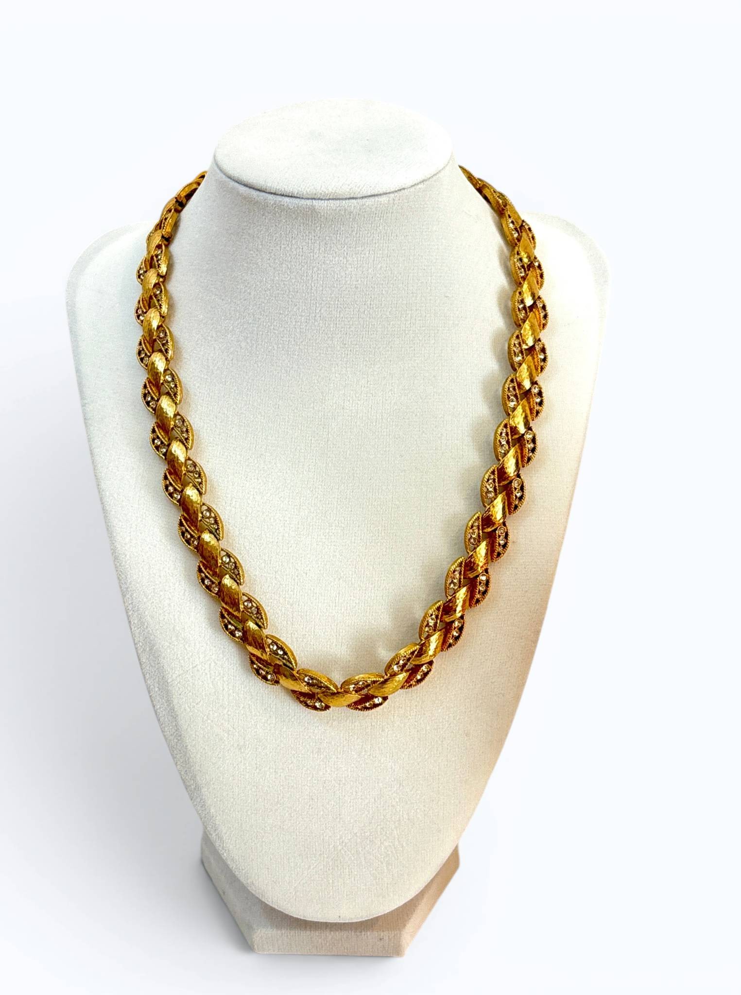 Vintage Nolan Miller Link Necklace: Gold-tone metal link necklace designed by Nolan Miller. Each link features textured gold detailing and rhinestone accents. The back of the clasp is stamped with the designers name. Bright finish and i