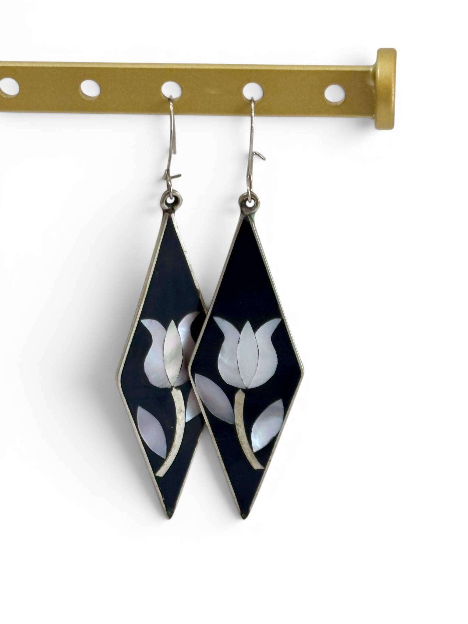 Mother-of-Pearl Inlay Tulip Motif Drop Earrings: Drop earrings featuring a rhombus-shaped design with mother-of-pearl inlay forming a tulip motif. The inlay is set against a black background, with a silver-tone metal base and hook-style ear wires. M