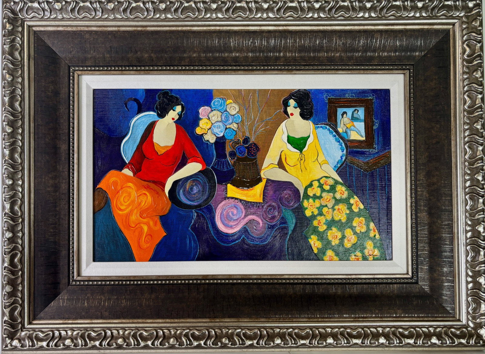 Tarkay ‘Conversation Over Flowers’ Embellished Serigraph on Canvas: An embellished serigraph on canvas by Itzchak Tarkay titled ‘Conversation Over Flowers.’ Features two women in brightly colored attire sitting with vases of vibrant flowers and abstract motifs in 