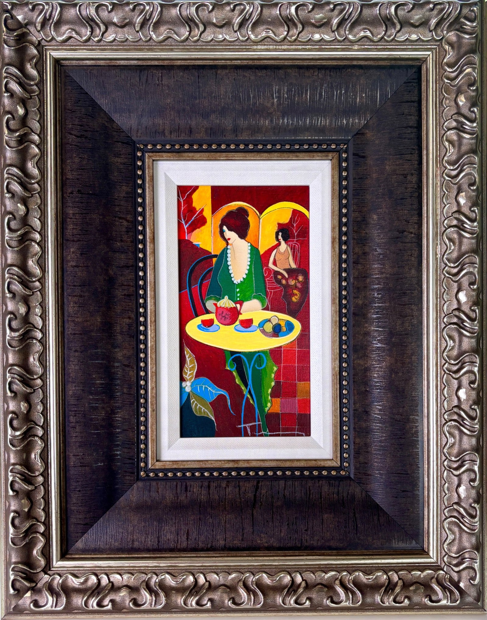 Tarkay ‘Charlena at Tea III’ Serigraph on Canvas: Tarkay ‘Charlena at Tea III’ serigraph on canvas depicting two women in a colorful cafe setting. The vibrant composition highlights bold red, yellow, and green tones, typical of Tarkay’s style. 