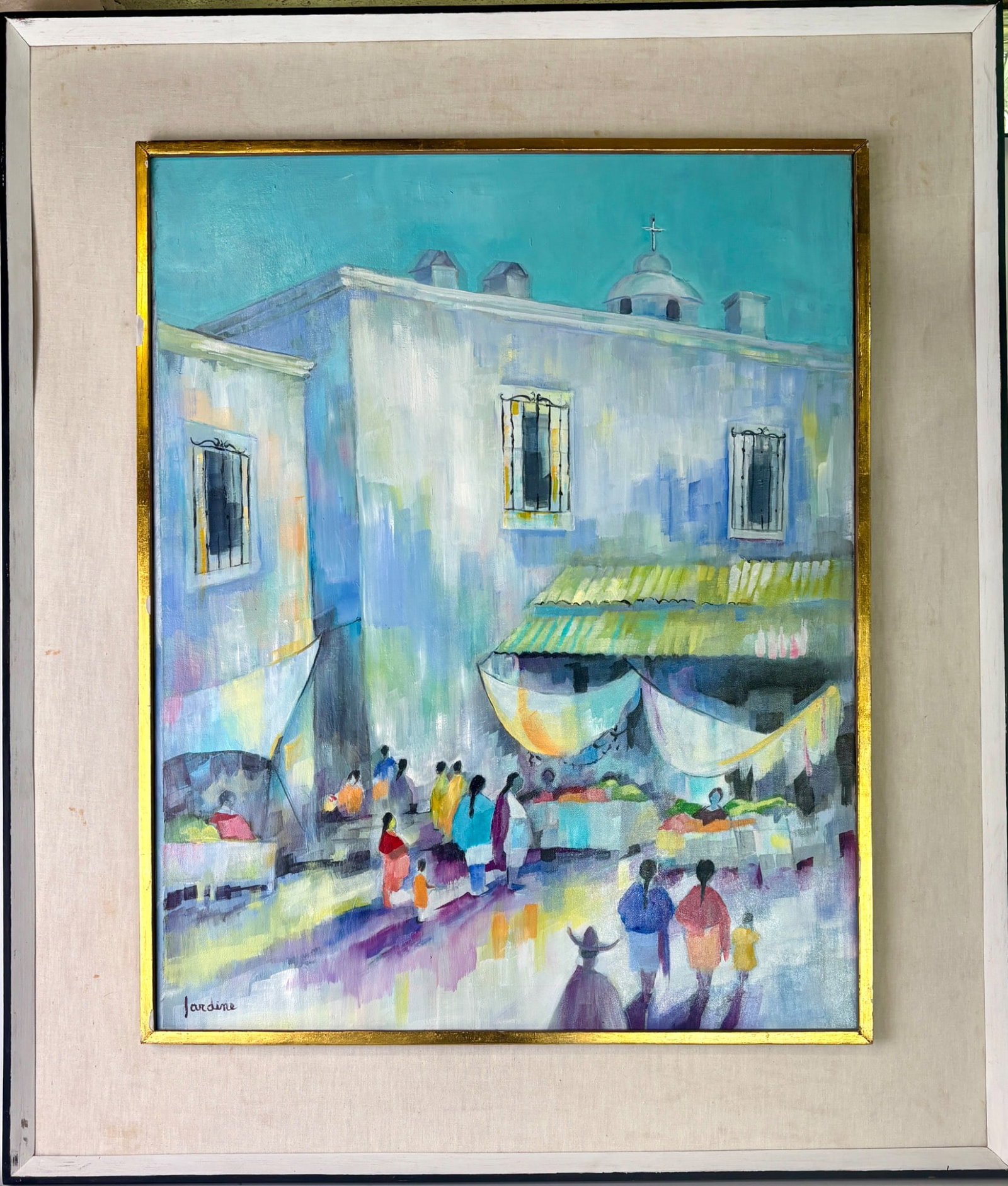 Market Scene Oil on Canvas Betty Jardine Mexico: An oil on canvas painting signed by the artist Jardine, depicting a market scene with colorful figures and architecture. The canvas bears a Galeria Atenea label on the back. Mounted in a gold-tone and