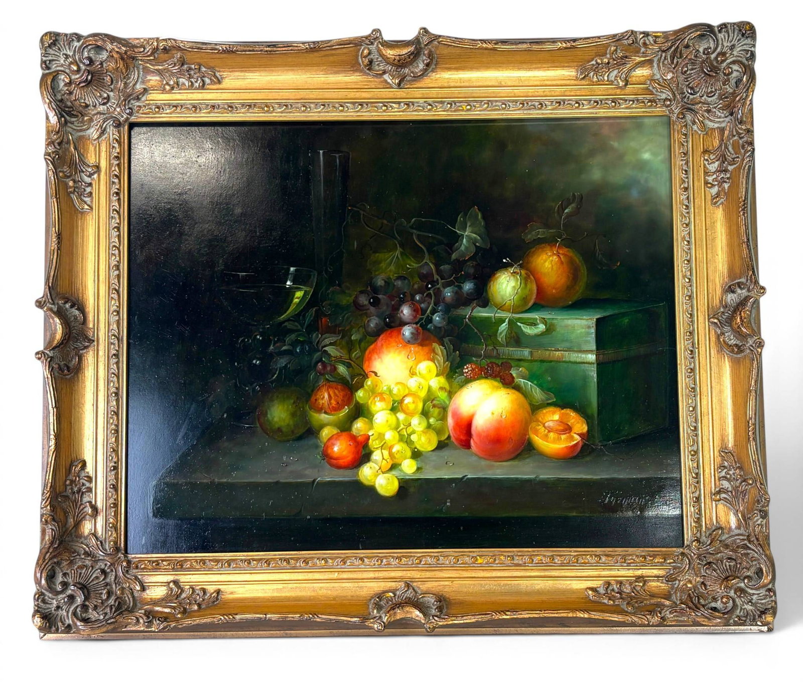 Fruit Still Life ‘Francois’ in Ornate Giltwood Frame: Still life oil painting depicting an arrangement of fruits, including peaches, grapes, plums, and a wine glass, set against a dark background. Signed ‘Francois’ in the lower right corner. Framed i
