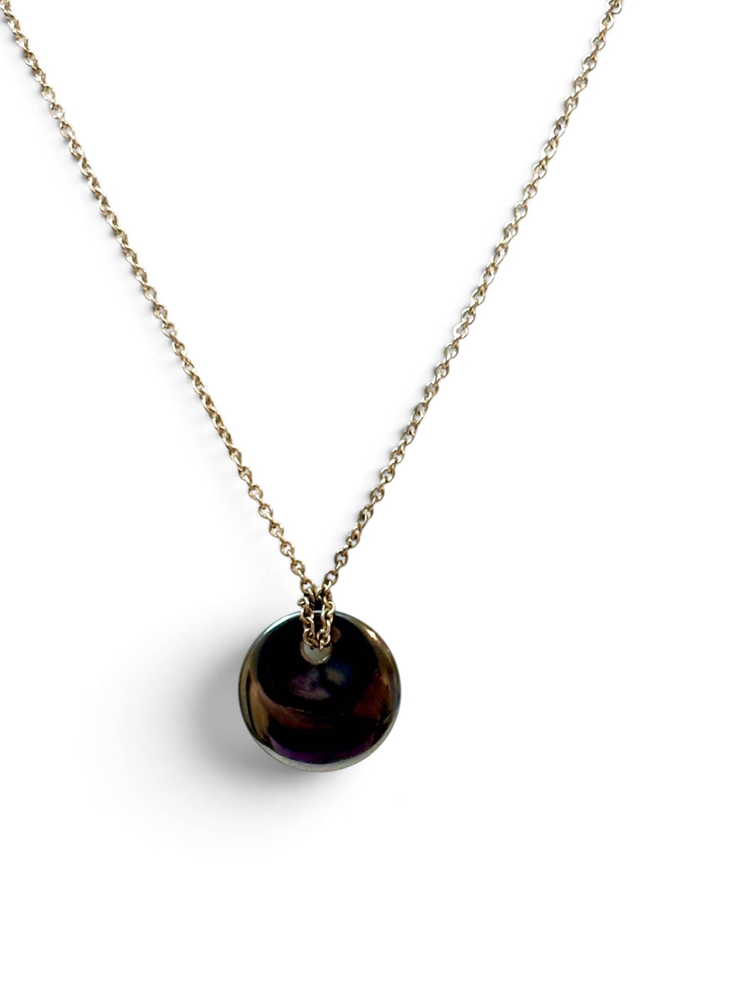 Sterling Silver Tiffany & Co. Elsa Peretti Pendant Necklace: Sterling silver chain necklace featuring a polished, black circular pendant by Elsa Peretti for Tiffany & Co. The chain is marked “AG 925” for sterling silver purity and “Peretti” indi