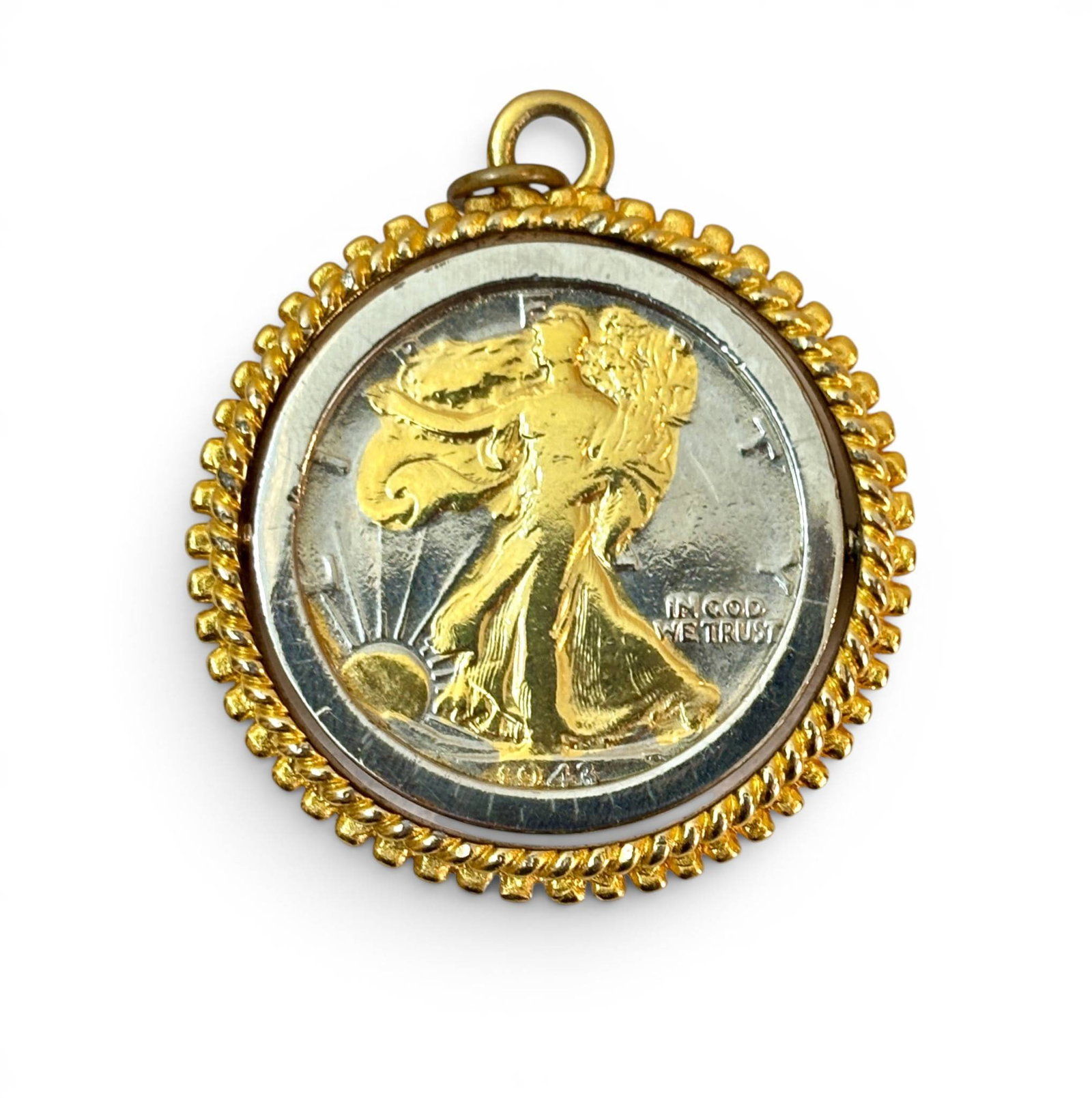 1943 Walking Liberty Silver Half Dollar Pendant: 1944 United States Walking Liberty silver half dollar coin set in a decorative gold-tone bezel. The coin features the iconic Walking Liberty design by Adolph A. Weinman and the date on the obverse. Th
