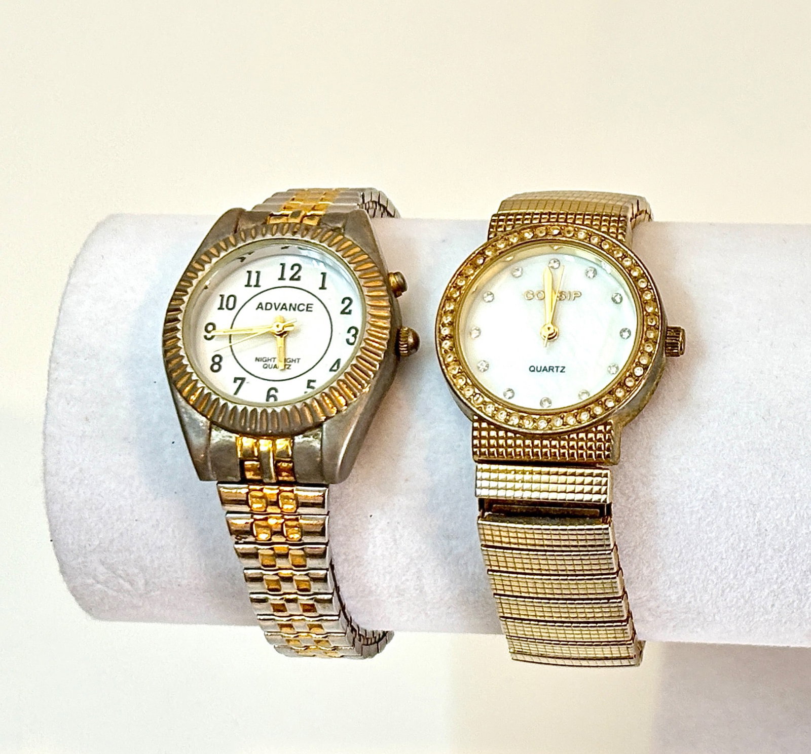 Two Vintage Women’s Quartz Wristwatches: Two quartz wristwatches. One features a gold and silver-tone stainless-steel bracelet with a round Advance Night Light dial, gold-tone hands, and two crowns. The other is a Gossip-branded watch with a