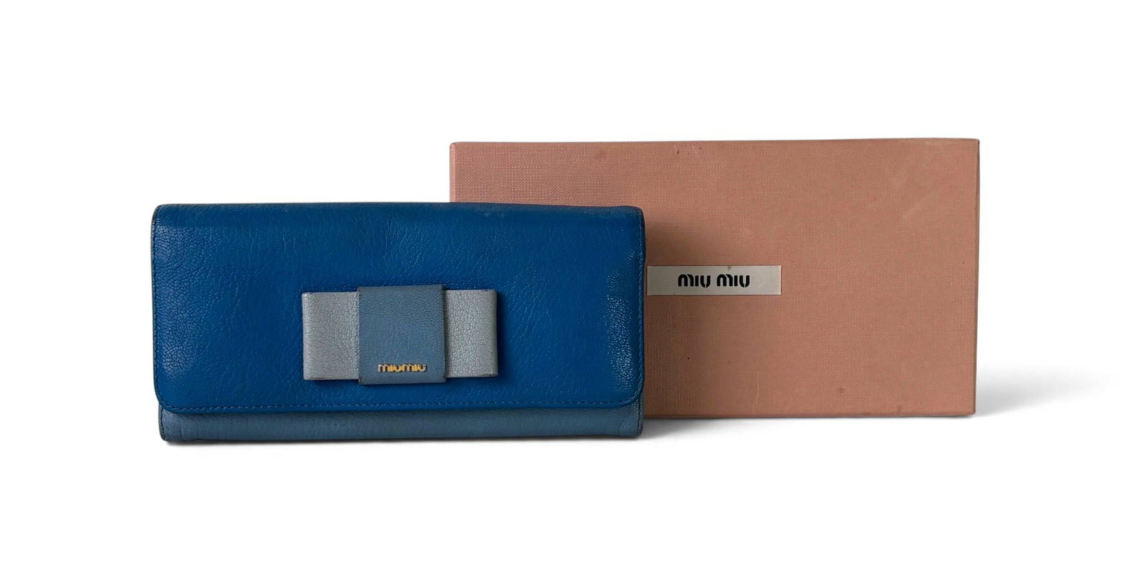 Miu Miu Madras Leather Long Wallet in Box: Miu Miu leather wallet in a two-tone blue and gray design, featuring a front bow detail with a small gold-tone ‘Miu Miu’ logo. Includes snap closures, an interior card compartment, and a zippered