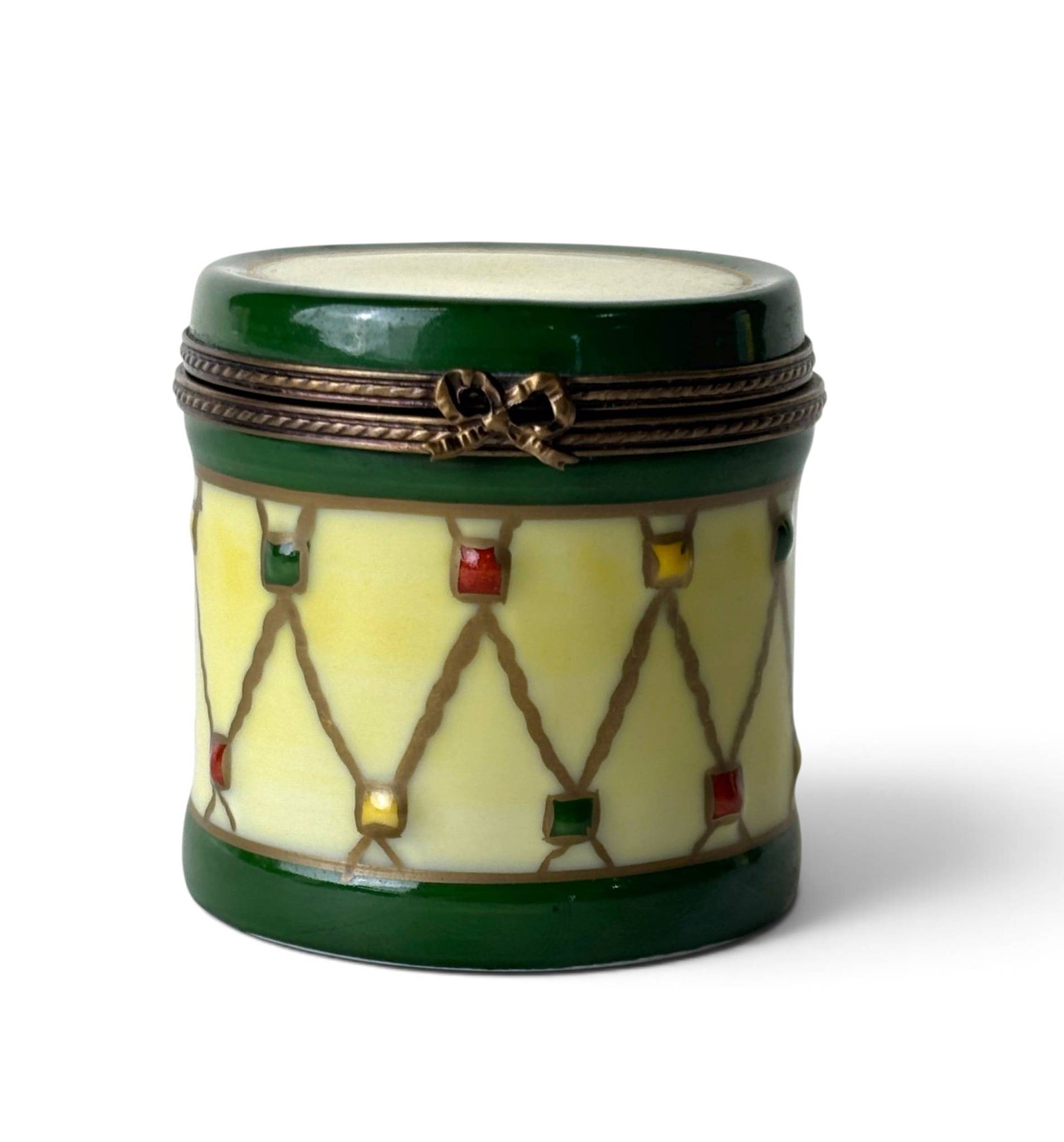 Hand-Painted Limoges Porcelain Drum-Shaped Trinket Box: A hand-painted porcelain trinket box crafted by Limoges, France, marked on the underside. Shaped like a drum, it features a green and yellow color palette with multi-colored accents. The metal hinge a