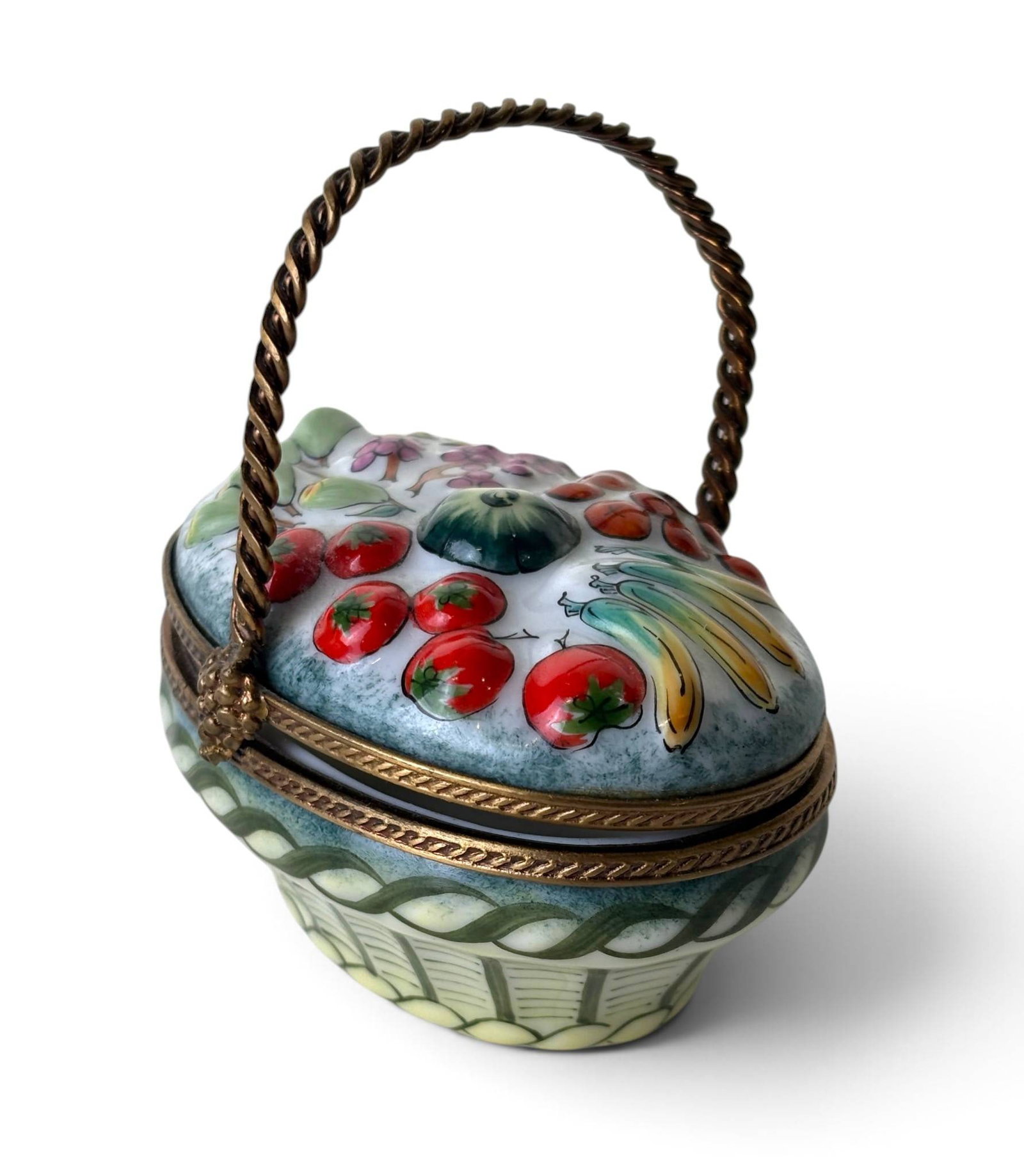 Hand-Painted Porcelain Trinket Box with Fruit and Vegetable Design by Rochard, Limoges: Oval porcelain trinket box with a hand-painted fruit and vegetable motif, including tomatoes, bananas, grapes, and other produce. Features a gold-tone metal clasp and twisted handle. Marked on the und