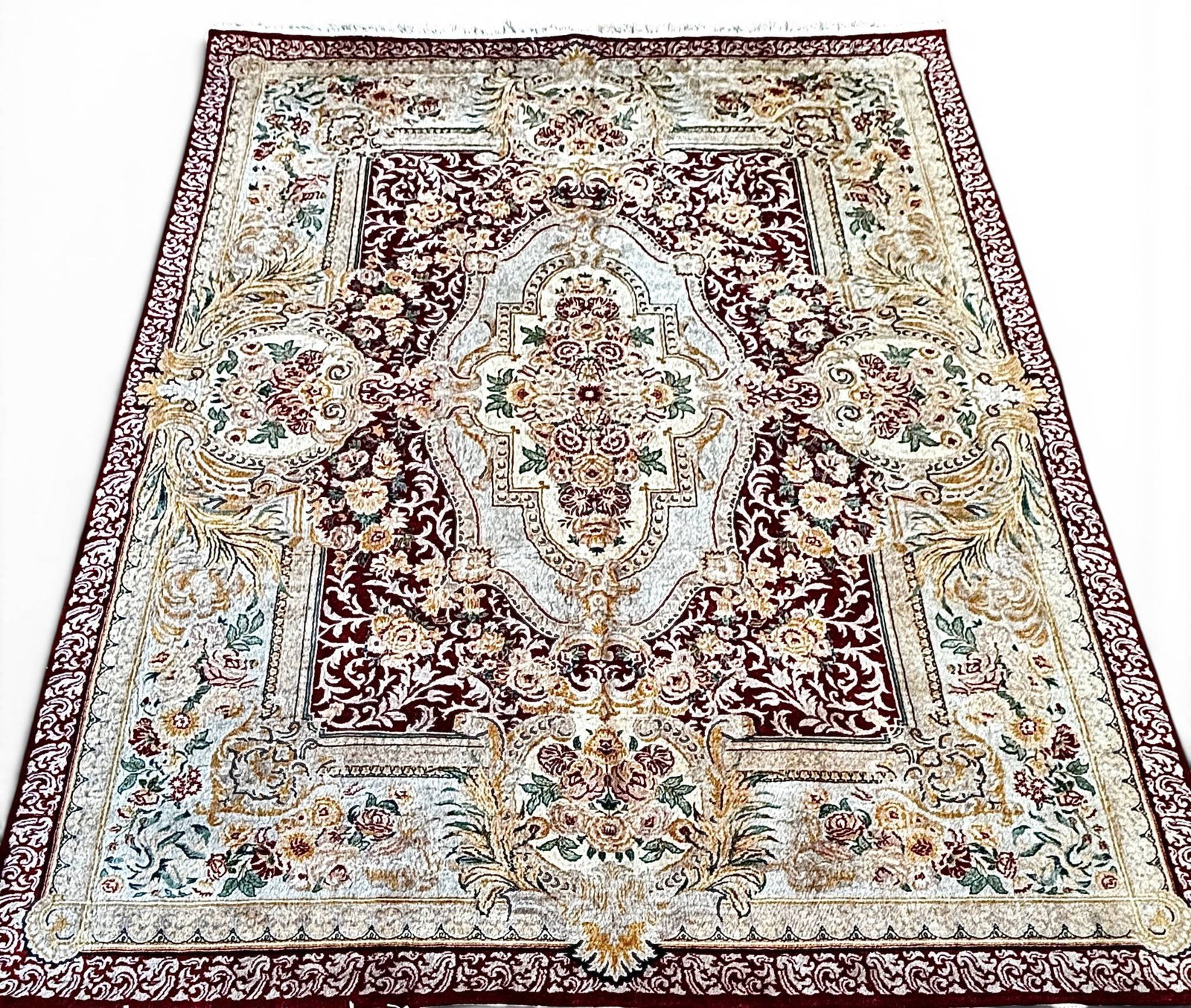 Pakistani Persian Tabriz Wool Rug: Pakistani Persian wool rug featuring a detailed floral medallion design in a red, ivory, and gold palette. Hand-knotted with 16/18 knots per square inch, sourced from Azhar’s Oriental Rugs.