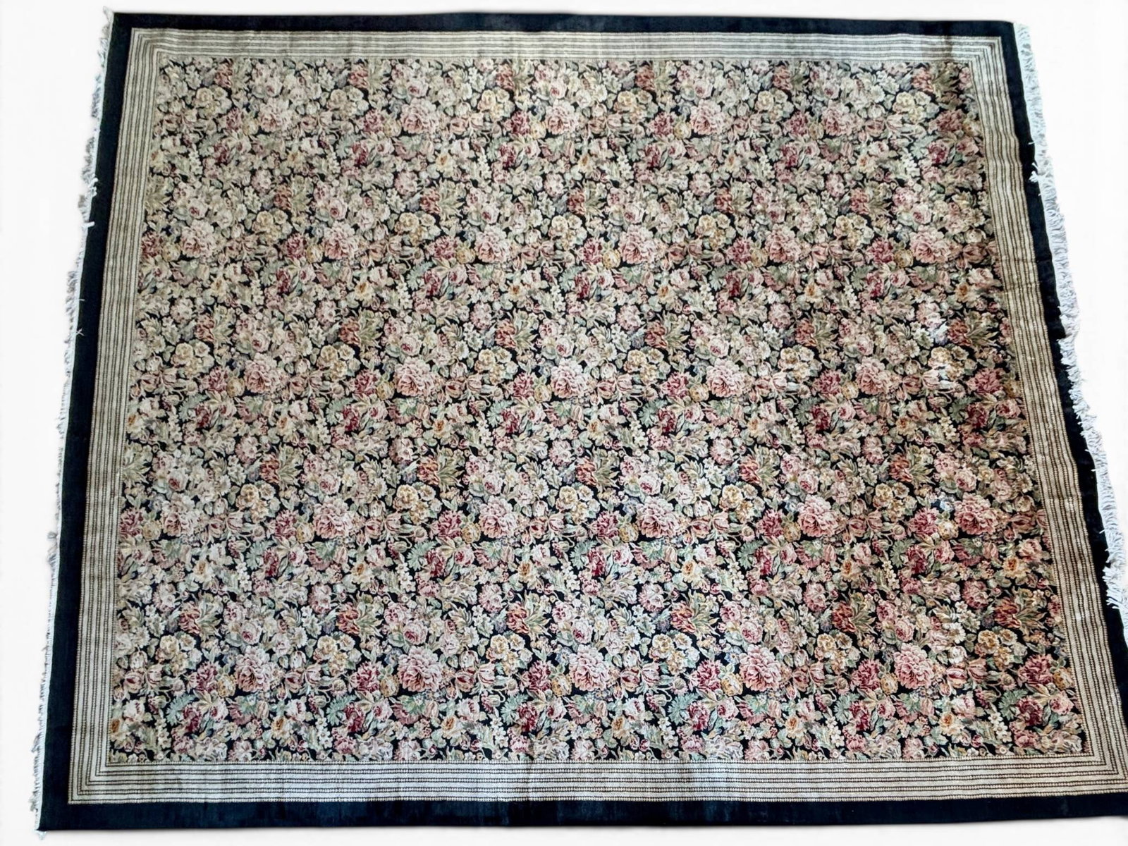 Pakistani Persian Wool Floral Rug 15 x 18: Hand-knotted Pakistani Persian wool rug with a detailed floral motif in multi-color tones over a dark blue background. Features a coordinating striped border. Purchased from Azhar’s Oriental Rugs