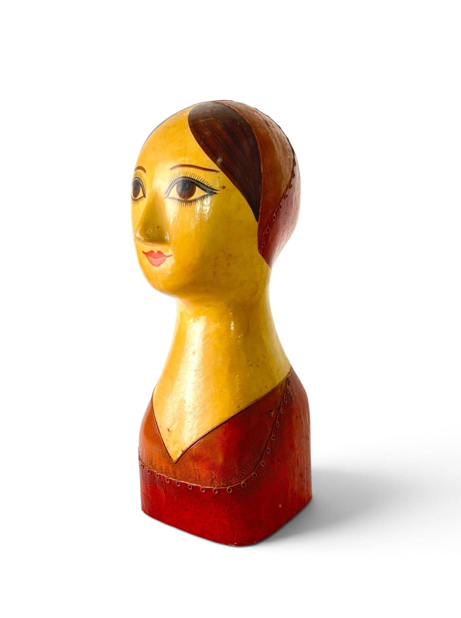 Gemma Taccogna and Fred Sexton Paper Mache Heads: A hand-crafted papier-mache bust featuring a stylized female figure with painted facial details and a red, orange, and beige color scheme. Back of the piece is signed ‘Gemma Taccogna’ and ‘Fred