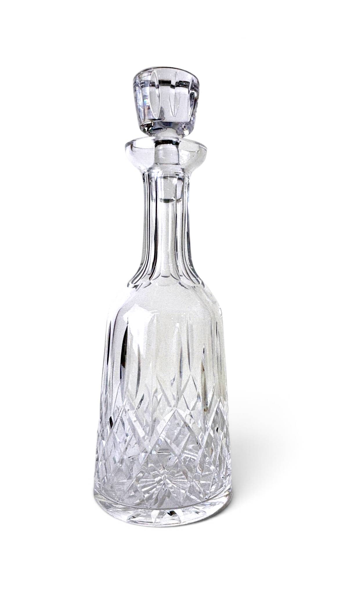 Waterford Lismore Crystal Decanter with Stopper: Waterford Lismore crystal decanter featuring the iconic diamond and wedge-cut pattern. Crafted from high-quality clear lead crystal, it includes the matching faceted stopper. The base showcases the si