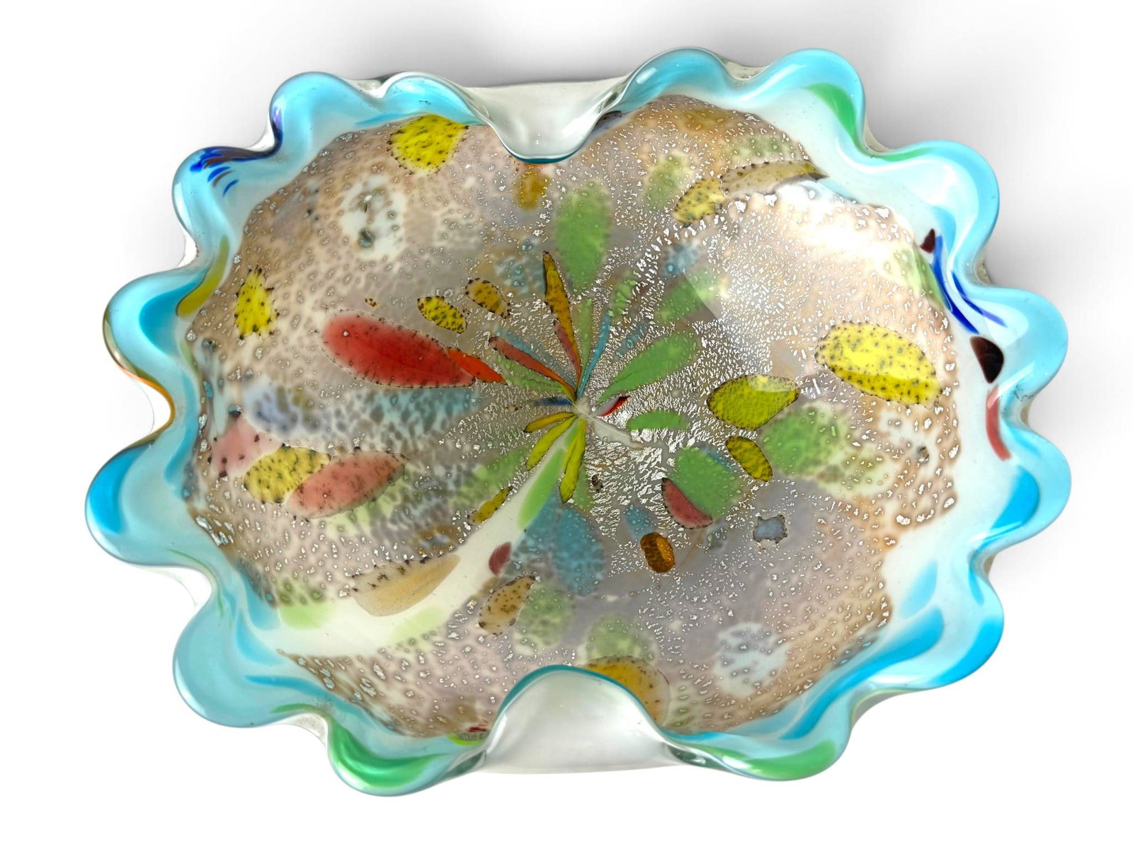 Murano Tutti Frutti Glass Bowl Italy: Handcrafted Murano glass bowl featuring a ruffled edge and multicolored inclusions characteristic of the ‘Tutti Frutti’ design. Made in Italy, the bowl showcases vibrant internal decorations and