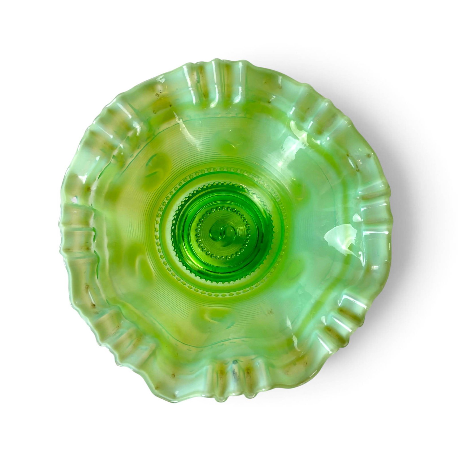 Jefferson Green Glass Opalescent Bowl Circa 1905: Jefferson green glass opalescent bowl in the Astro pattern, measuring 8.5 inches in diameter. Produced circa 1905, the bowl features an undulating rim, raised bead detailing, and ribbed texture. The g