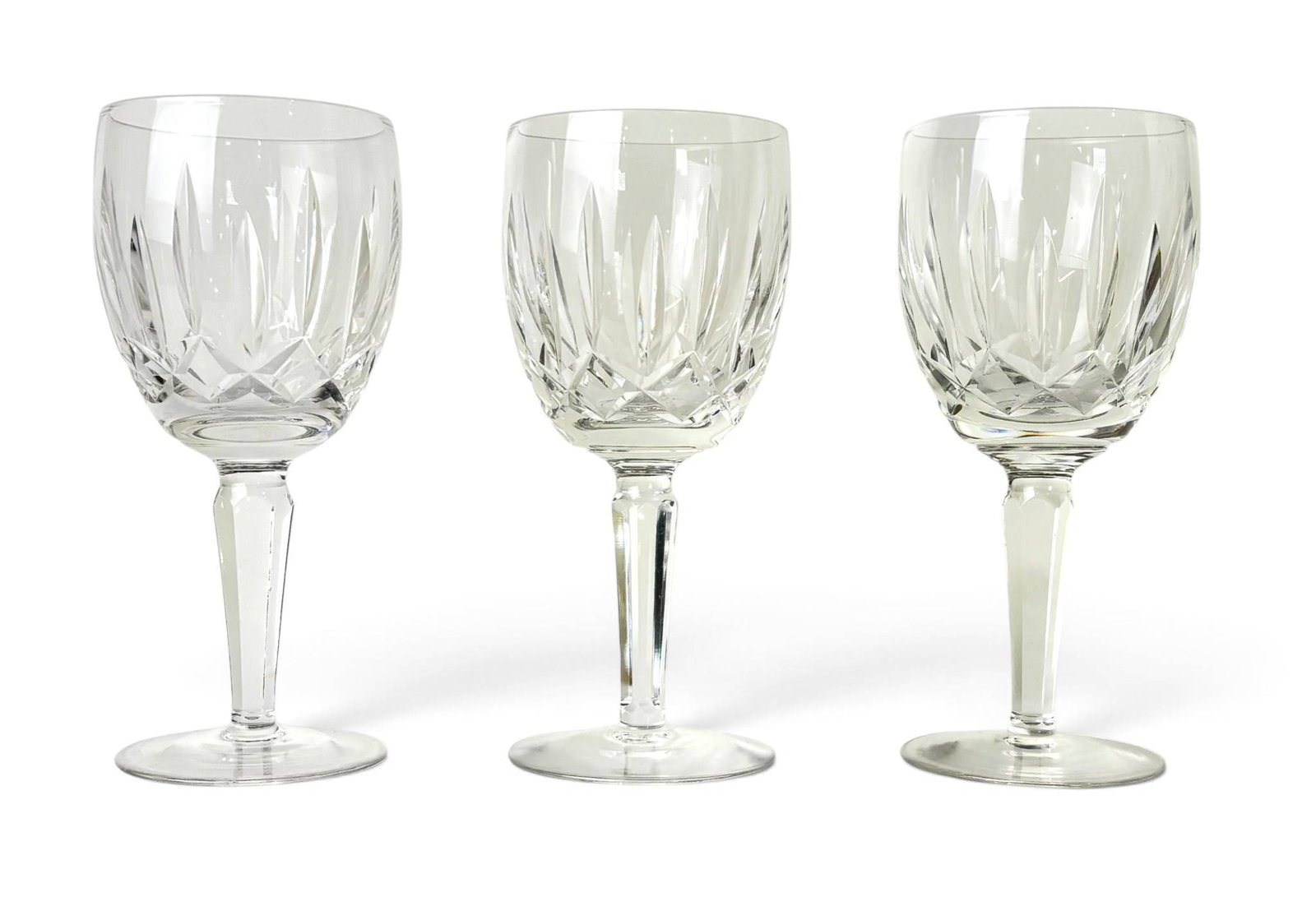 Three Waterford Kildare Claret Glasses: Three Waterford Kildare claret glasses featuring the iconic Kildare cut pattern with vertical and diamond cuts on a clear crystal design. Each glass has a faceted stem and circular base,
