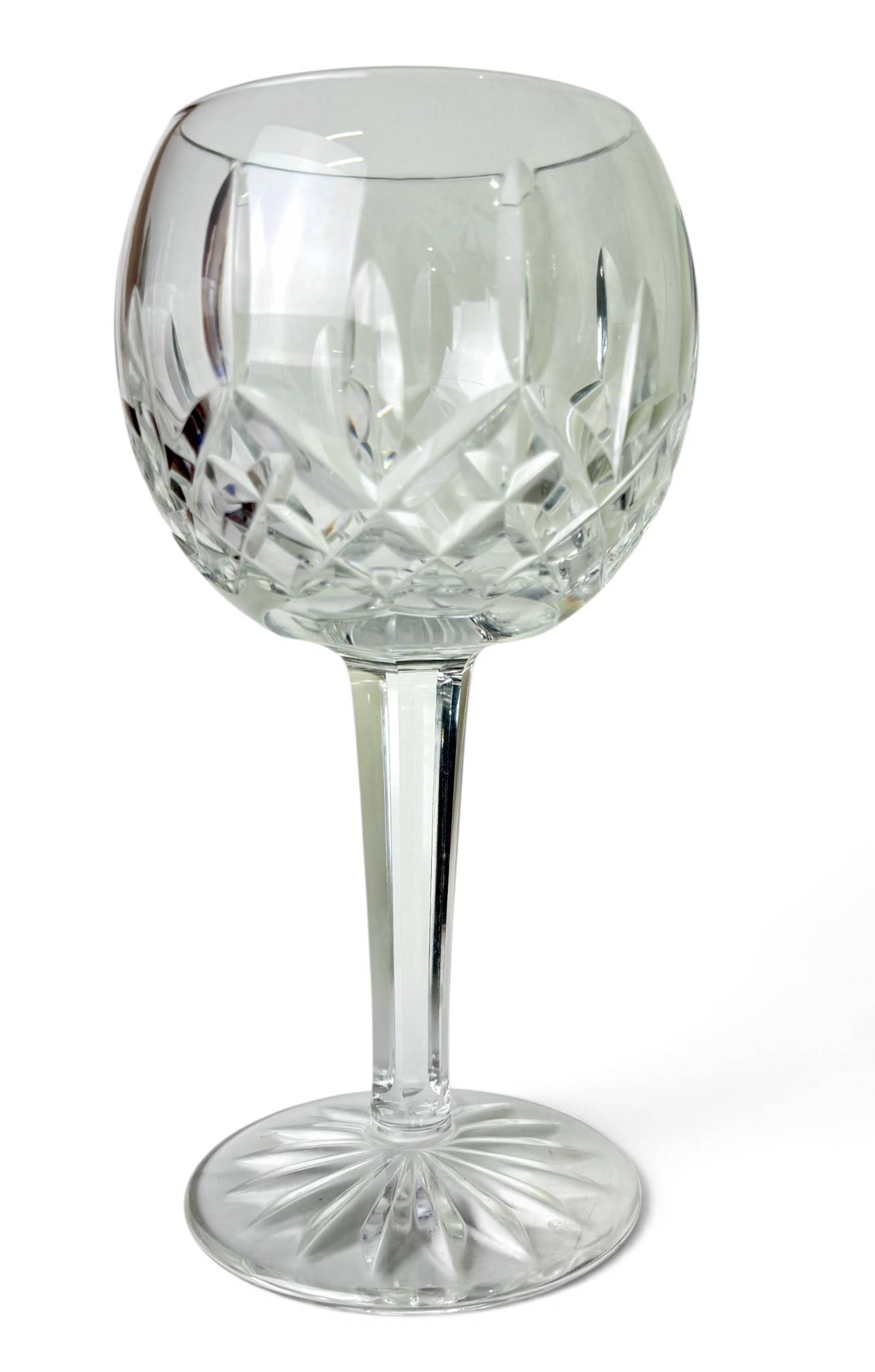 Six Waterford Lismore Crystal Wine Balloons: Six Waterford Lismore wine balloons featuring the iconic Lismore pattern with diamond and wedge cuts. Crafted from clear, high-quality crystal, each glass includes a round bowl, a faceted stem, and a 