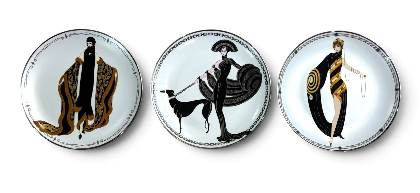 Three House of Erte Plates: Three fine porcelain plates from the Franklin Mint’s House of Erte limited edition series: ‘Symphony in Black,’ ‘Mystic,’ and ‘Pearls and Emeralds.’ Each plate features vibrant Art Deco-