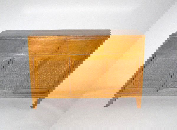 Russel Wright credenza with sliding doors c.1950: 30.5h x 44w x 15d inches, blond mahogany, rattan, Manufactured by Conani Ball Furniture Makers