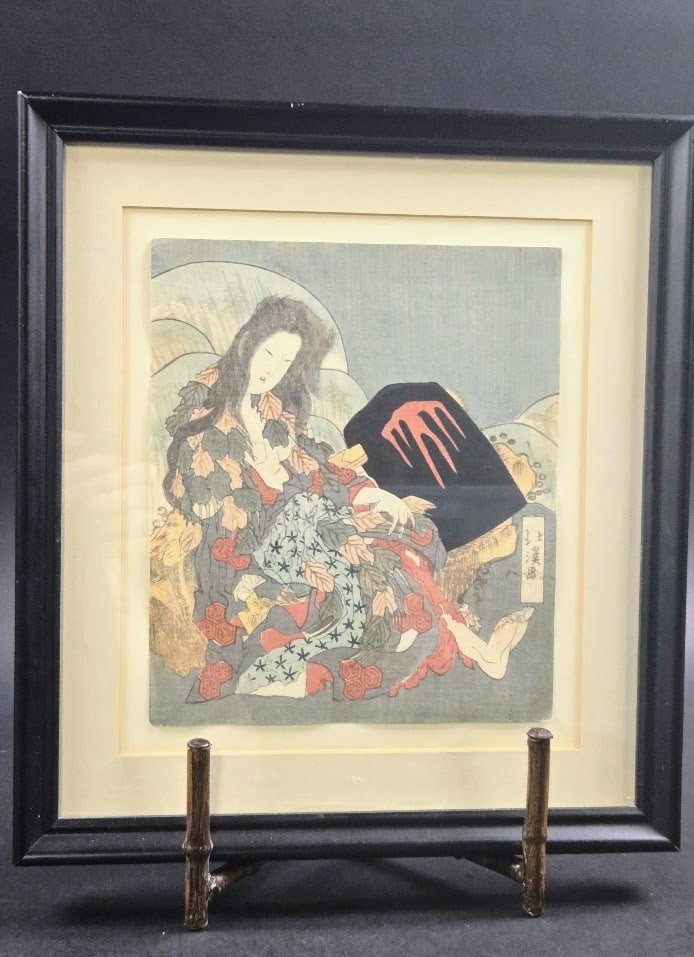 Japanese woodblock "Surimono: The Tale of the Wild Mountain Witch"" by Totoya Hokkei 1780–1850: a Japanese woodblock print titled Surimono: The Tale of the Wild Mountain Witch Woman" by Totoya Hokkei 1780–1850.The print depicts Yama-uba, an allegorical figure known as the mountain witch, seate