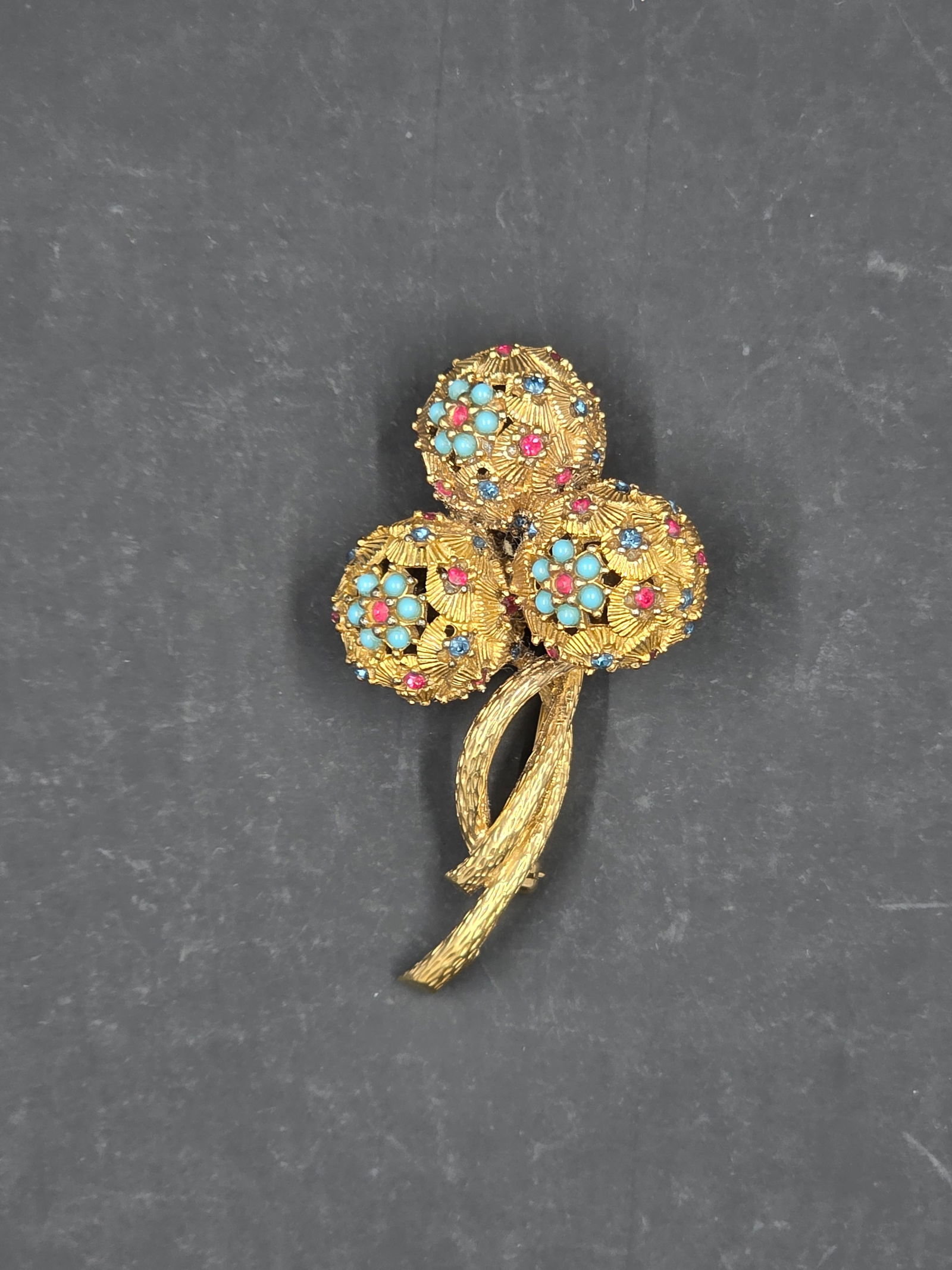 Ciner Flower Bud Rhinestone Brooch: A vintage Ciner flower brooch with rhinestones is a quintessential example of high-end costume jewelry from a company that has a rich history of crafting pieces to look and feel like genuine fine jewe