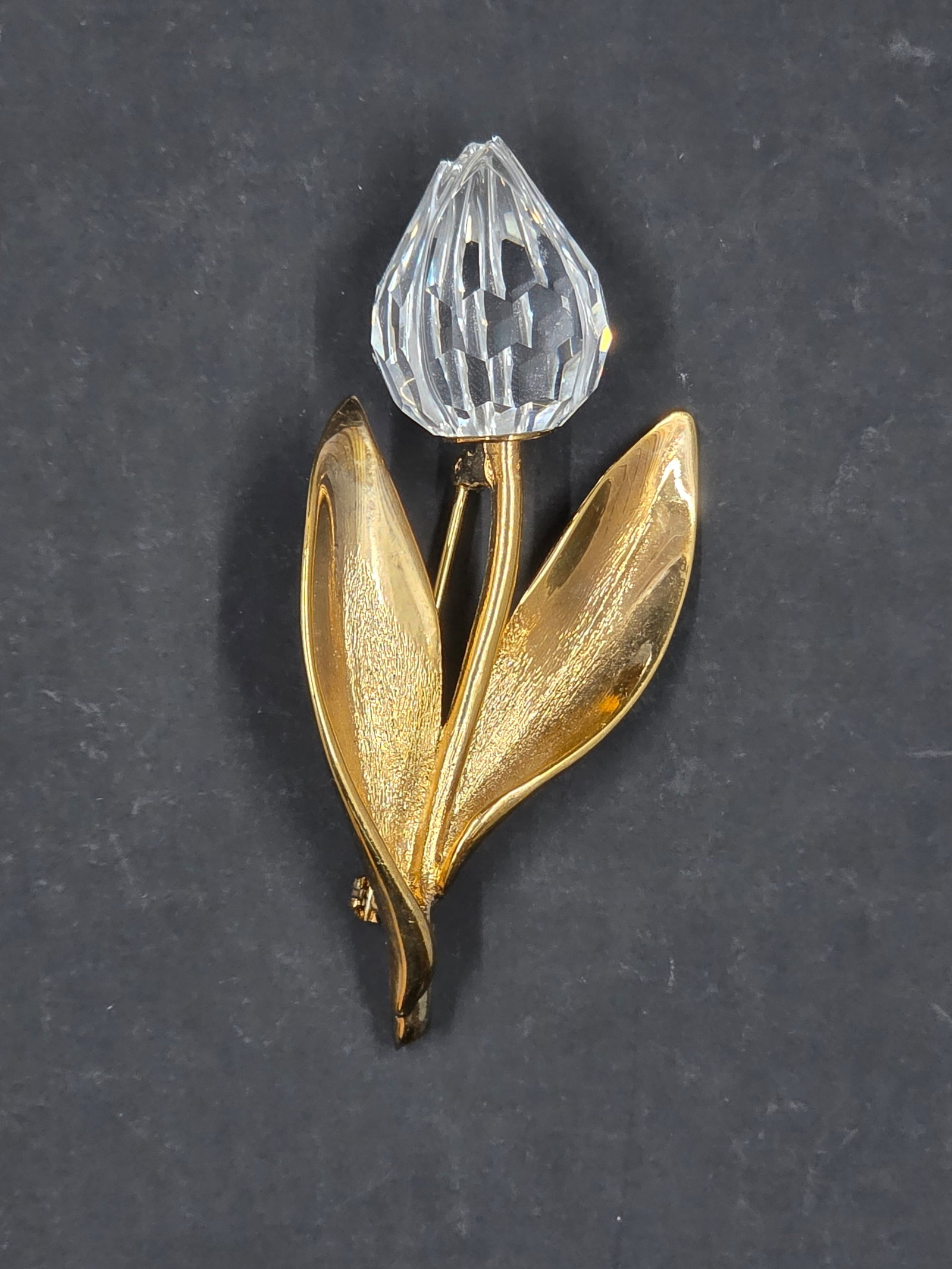 Swarovski Gold Toned Tulip Brooch: A Swarovski gold-toned tulip brooch is a beautiful and collectible piece of costume jewelry. Swarovski, a company famous for its precision-cut crystals, has a long history of creating high-quality jew